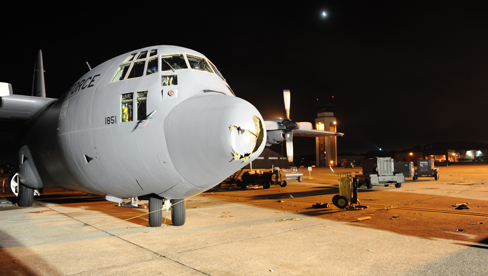 Damaged C-130 Hercules aircraft sit on the flightline April 26, 2011, at Little Rock Air Force Base, Ark., hours after a tornado struck at approximately 8 p.m. The tornado damaged three C-130 aircraft. In addition to aircraft damage, the base sustained significant damage to buildings along the flightline, the fire department and base housing. (U. S. Air Force photo by Airman 1st Class Ellora Stewart)