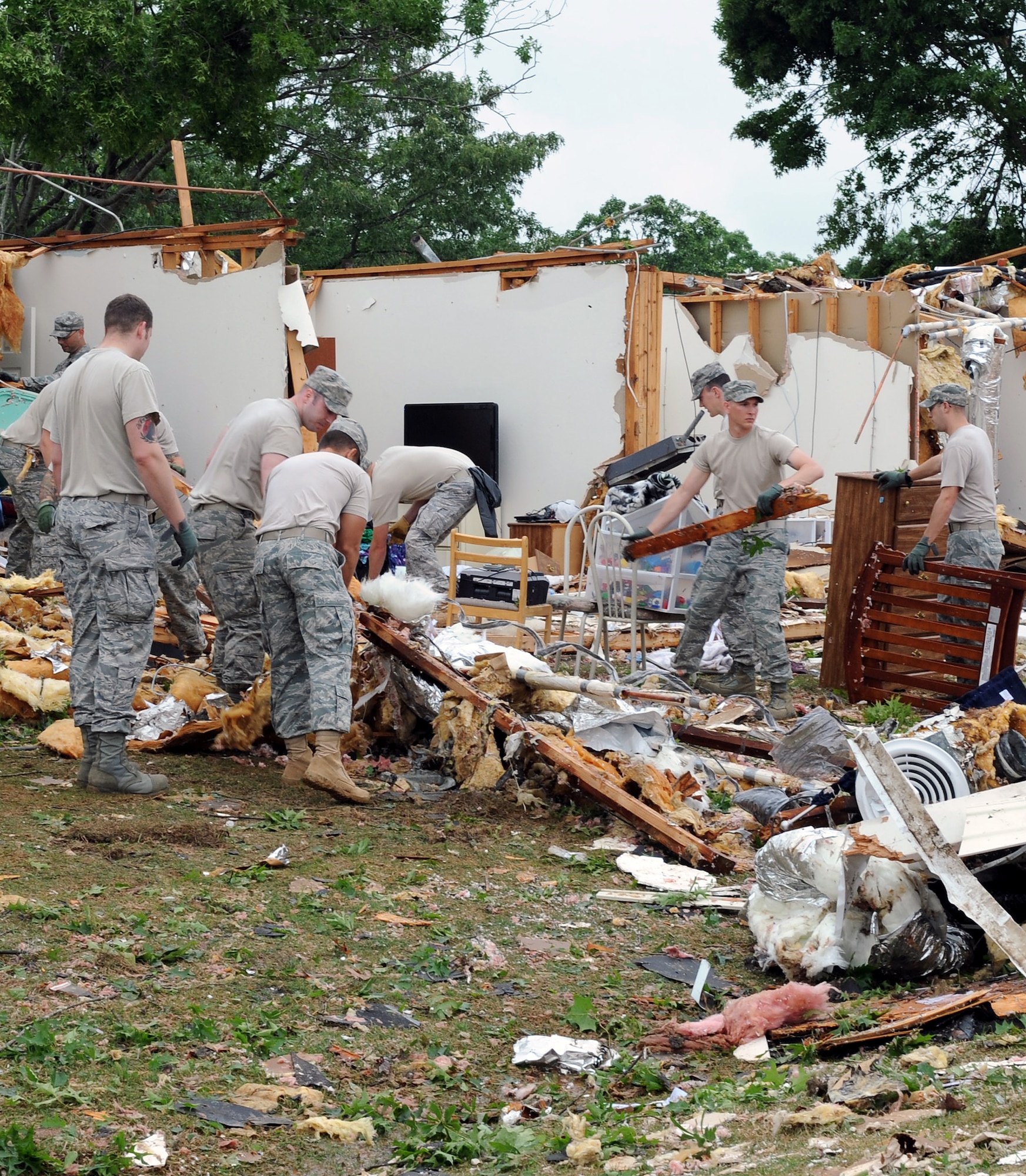 Airmen work together in an effort to clear debris April 26, 2011, at Little Rock Air Force Base, Ark., after a tornado struck the base at approximately 8 p.m. April 25. Little Rock AFB sustained significant damage to base housing, the base exchange, fire department and buildings along the flightline. (U. S. Air Force photo by Airman 1st Class Ellora Stewart)