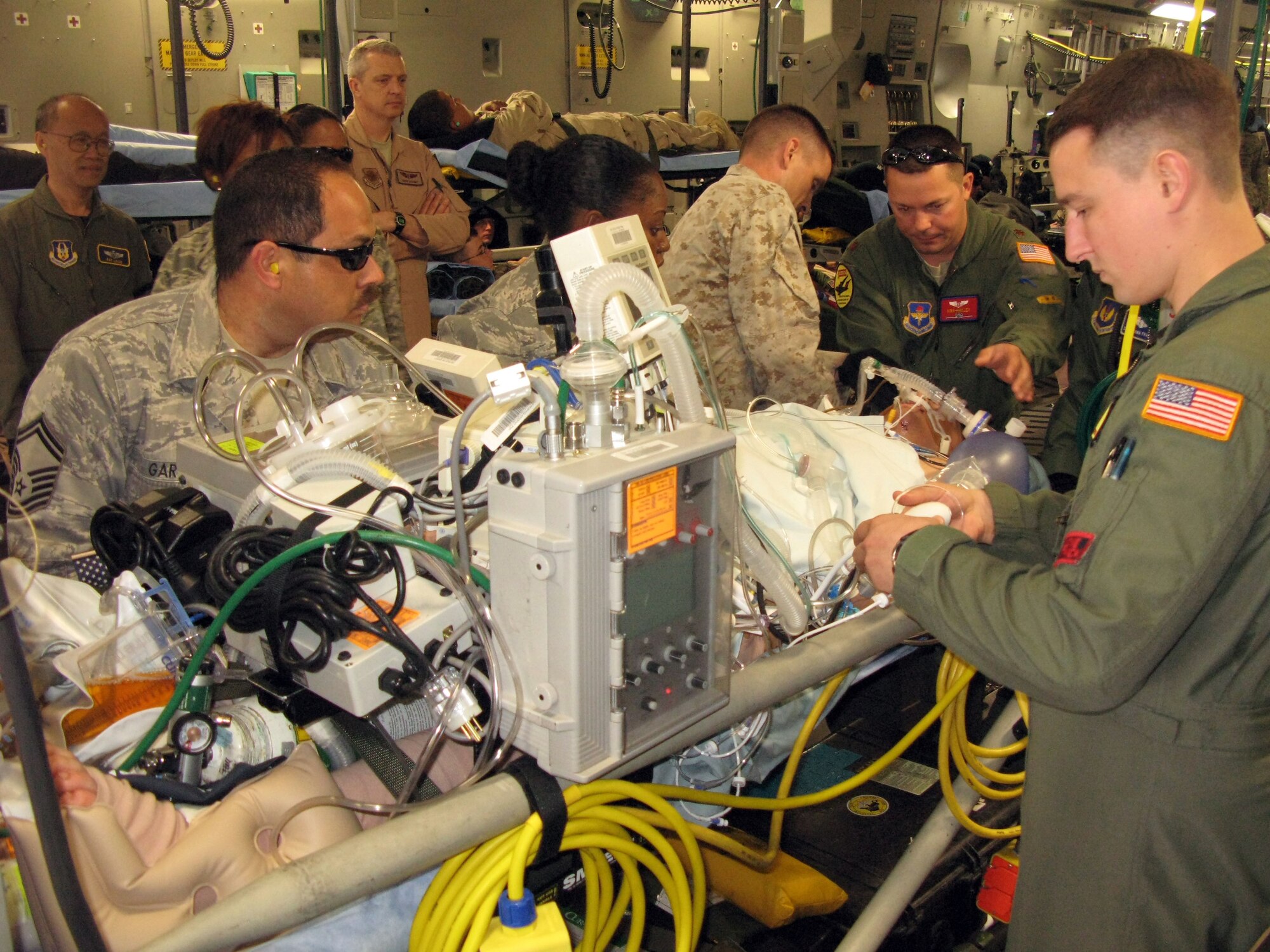 Aeromedical evacuation and critical care air transport team members prepare Army Spc. Dustin Morrison, an Iowa Army National Guardsman severely wounded by an improvised explosive device attack in Afghanistan, for an April 26, 2011, flight from Ramstein Air Base, Germany, to Washington, D.C., for treatment at Walter Reed Army Medical Center. (Defense Department photo/Donna Miles )