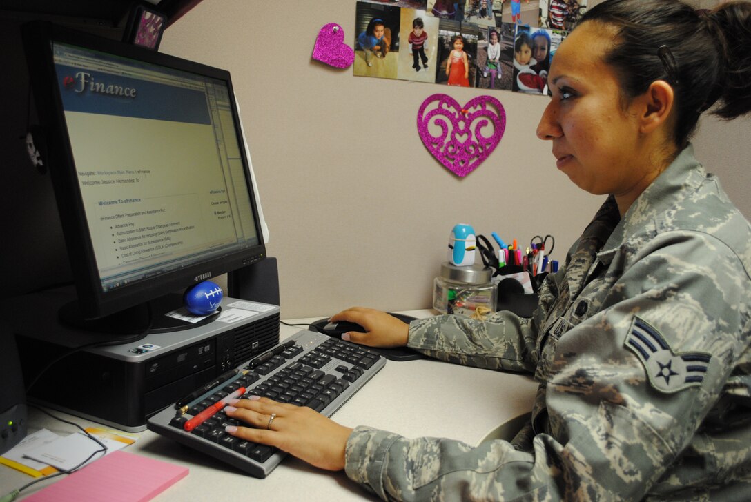 Senior Airman Jessica Hernandez, 433rd Force Support Squadron services journeyman, logs on to the eFinance Workspace website at her work area April 26, 2011.  The eFinance Workspace site is the store front to complete a variety of financial processes and documents such as travel vouchers. (U.S. Air Force photo/Senior Airman Luis Loza Gutierrez) 