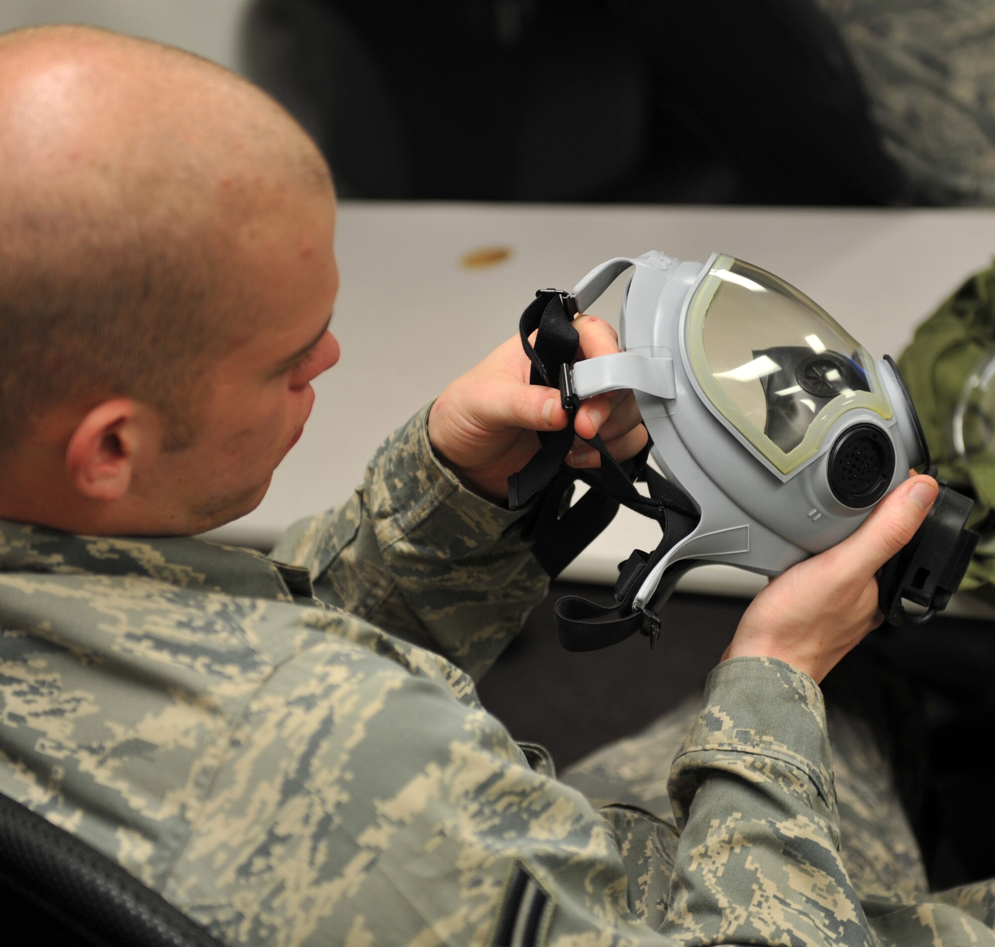 Airman 1st Class Travis Hahn-Holmes, 375th Communications Squadron cable and antenna maintenance, inspects his gas mask during chemical, biological, radiological and nuclear training April 26, 2011 at Scott Air Base, Ill.  A gas mask inspection should be performed every six months when not in a combat zone or every seven days while in a combat zone. (U.S. Air Force photo/ Airman 1st Class Divine Cox)