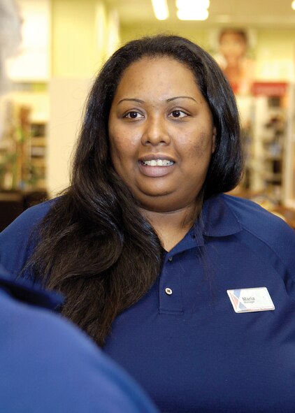 Back home at Tinker, Exchange acting sales area manager Maria Hood discusses merchandise displays with an Exchange associate.  Ms. Hood spent more than three years deployed with the Exchange, moving from an associate to a manager under harsh conditions that helped her grow personally and professionally. (Air Force photo by Margo Wright)