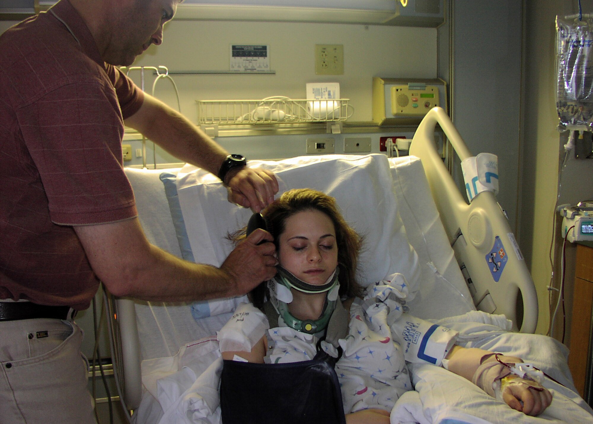 BUCKLEY AIR FORCE BASE, Colo. -- Lt. Col. Kelly Kanapaux, 460th Communications Squadron, holds a phone to his daughter's ear after her car accident in 2009. This photo shows the injuries his daughter sustained when a suspected drunk driver crashed into her car injuring her and her fiancé and his daughter. (Photo courtesy of Lt. Col. Kelly Kanapaux)
