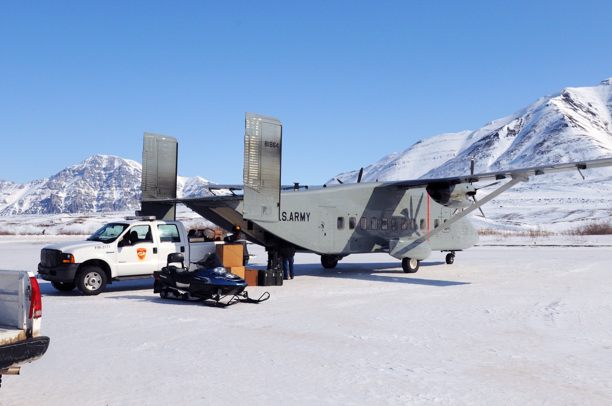 Anaktuvuk Pass residents help 807th Medical Command (Deployment Support) Soldiers unload medical and dental supplies from an Alaska Army National Guard C-23 Sherpa during Operation Arctic Care 2011. (Air Force photo by Lt. Col. Brent Campbell)