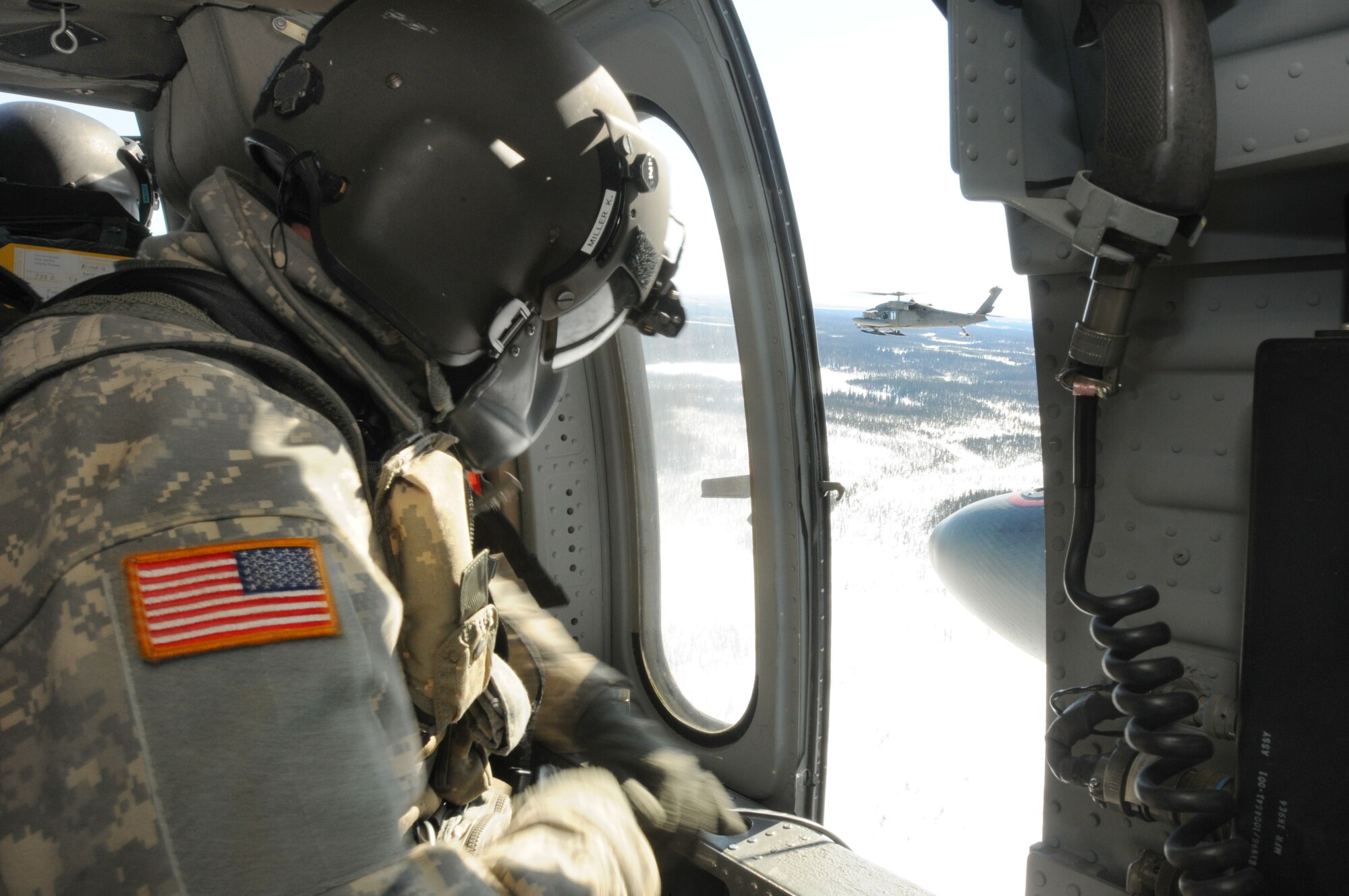 An Alaska Army National Guard crew chief from A Company, 1-207th Aviation Battalion, maintains watch during a resupply mission in support of Operation Arctic Care 2011. (Air Force photo/Sergeant Craig Anderson)