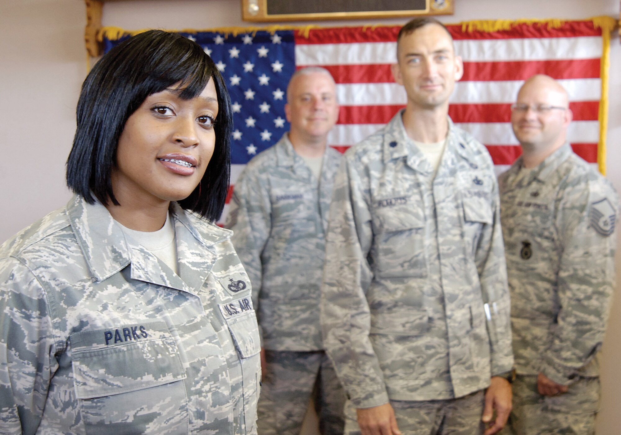 Staff Sgt. Deondra Parks credits her security forces training in staying calm when a stranger with killing on his mind shot her in a book store last year.  Support and encouragement from 72nd Security Forces Squadron leadership, including Senior Master Sgt. George Barkman, operations superintendent; Lt. Col. Troy Roberts, commander; and Master Sgt. Chris White, assistant first sergeant, from left, just re-enforced her beliefs that the Air Force family would help in times of need. 
