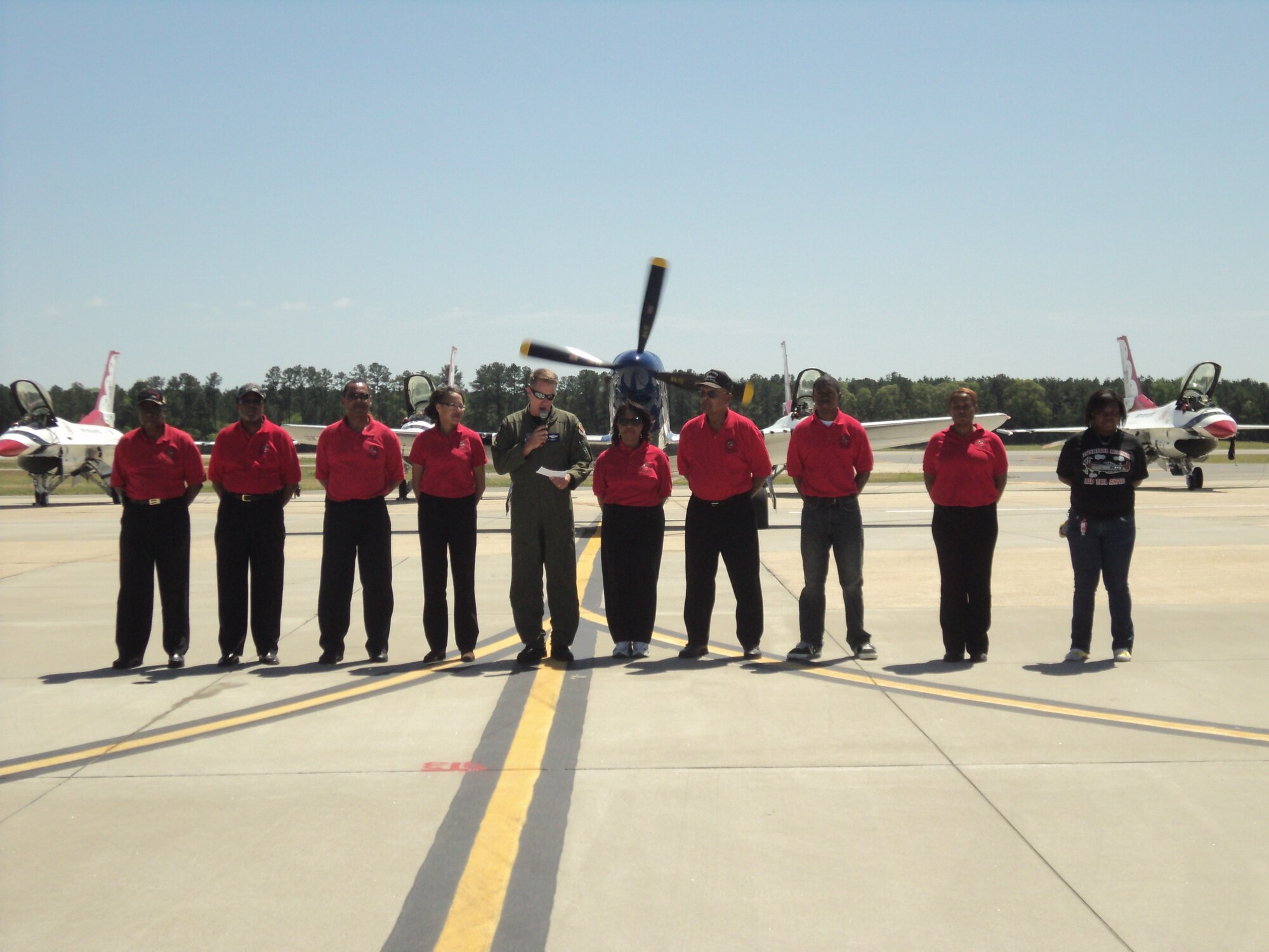 SEYMOUR JOHNSON AIR FORCE BASE, N.C. – Colonel Patrick Doherty, 4th Fighter Wing commander, honors family members of Tuskegee Airmen in front of a P-51 Mustang during the 2011 Wings Over Wayne Air Show and Open House here April 17. The P-51 Mustang was flown by Tuskegee Airmen during their entry into World War II. Honorees are from the Wilson V. Eagleson Chapter of Tuskegee Airmen in Dudley. Colonel Doherty invited the group to celebrate the air show and acknowledge contributions of the Tuskegee Airmen in World War II and the history of the 4th FW. The organization inspires young people through social and educational activities. Their mission encourages studious sacrifice and attainment of marketable skills in the fields of aviation and aerospace sciences. (U.S. Air Force photo by Staff Sgt. Heather Stanton)(RELEASED)  