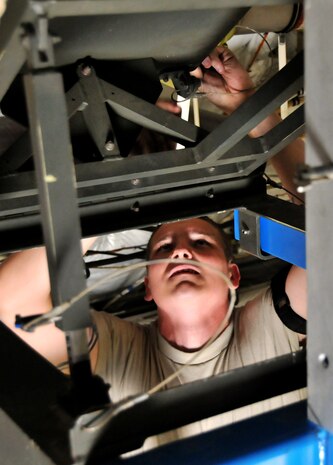Airman 1st Class Eric Duncan removes a safety pin attached to a 46-person life raft stored on the roof of a C-17 April 25, on Joint Base Charleston - Air Base. The life rafts must be replaced every three years and take approximately two hours to replace. Airman Duncan is a crew chief from the 437th Aircraft Maintenance Squadron. (U.S. Air Force photo by /Airman 1st Class Jared Trimarchi)