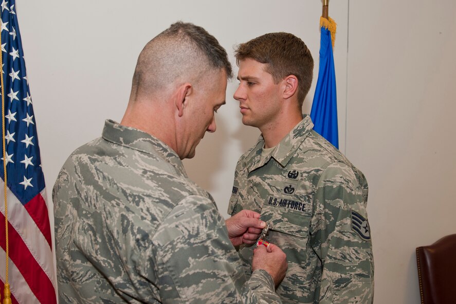 Staff Sgt. Dallas Bozeman, 23rd Civil Engineer Squadron explosive ordnance disposal craftsman, receives a Bronze Star Medal from Col. Randall Richert, 820th Base Defense Group commander, April 22 at Moody Air Force Base, Ga. Sergeant Bozeman earned the medal while performing duties as an EOD team leader during a deployment in support of Operation Enduring Freedom from August 2010 to February 2011. (U.S. Air Force photo/Staff Sgt. Jamal D. Sutter)(RELEASED)