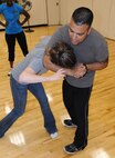 LAUGHLIN AIR FORCE BASE, Texas – Tech. Sgt. Diana Vela and Staff Sgt. Bryan Garcia, both of the 47th Security Forces Squadron, demonstrate self defense techniques to a class at Laughlin’s Losano Fitness Center April 21. The class is in recognition of sexual assault awareness month and takes place at the end of the Zumba classes at the gym. (U.S. Air Force photo by Airman 1st Class Blake Mize)
