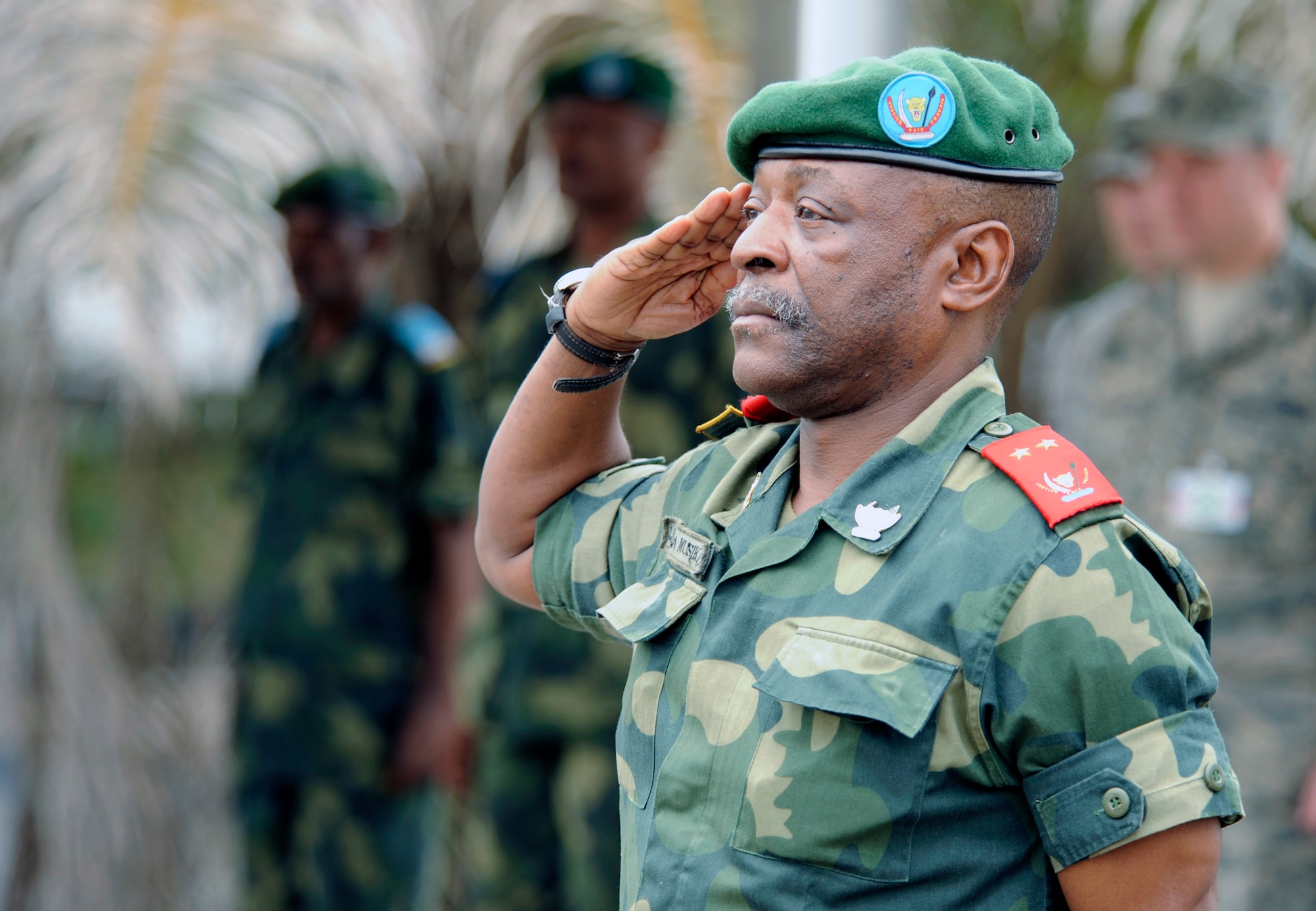 Congolese Maj. Gen. Marcellin Lukama Musikami salutes members of the Democratic Republic of the Congo military police force before the opening ceremonies for the MEDLITE 11 exercise April 25, 2011, in Kinshasa, Democratic of the Congo. MEDLITE 11 is a joint medical exercise focused on aeromedical evacuation, to improve the readiness of U.S. Air Force and DRC personnel. (U.S. Air Force photo/Tech. Sgt. Todd Wivell)