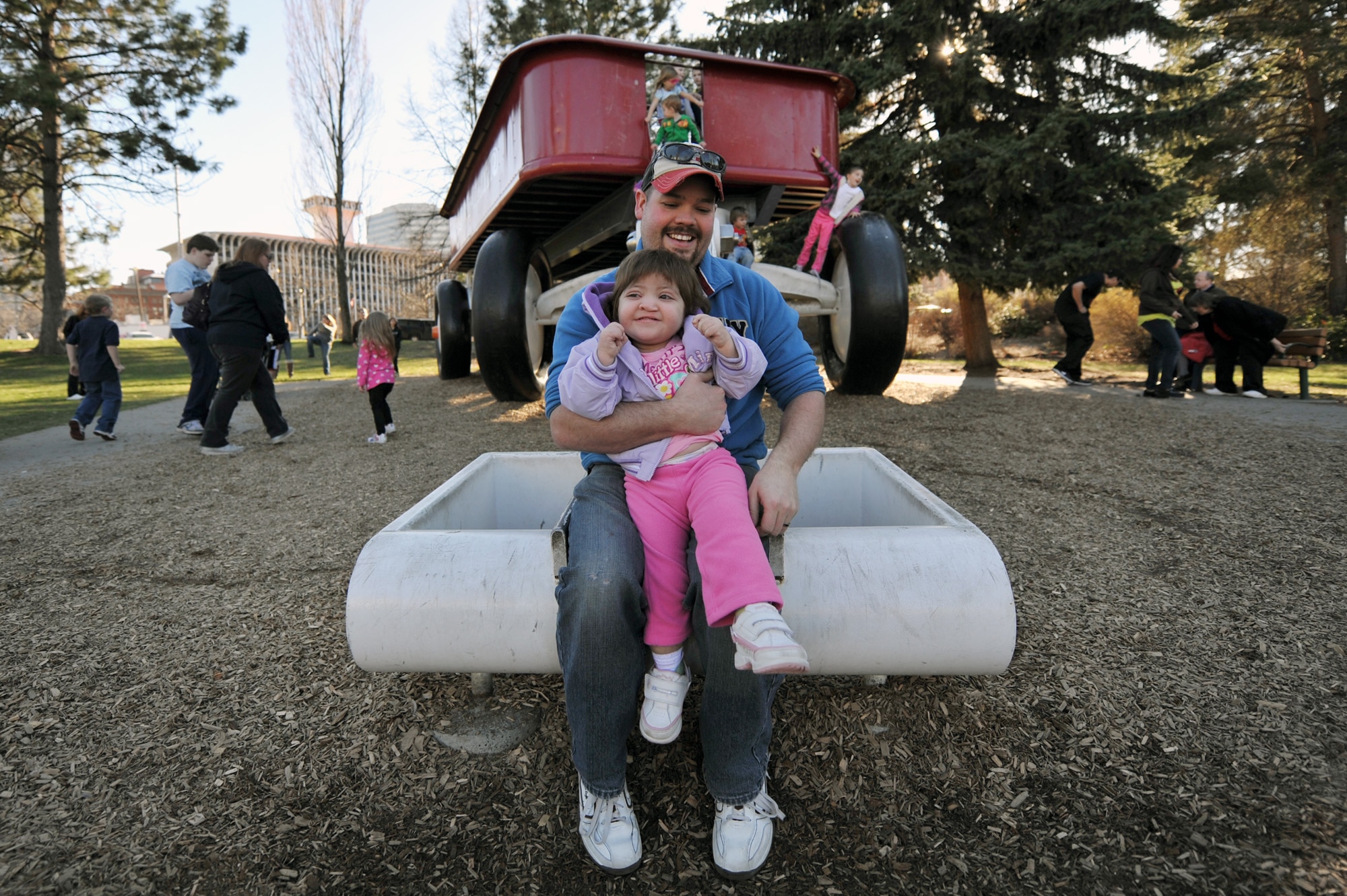 Matt Whitford holds his daughter, Braelyn Whitford, as they slide down a Red Wagon slide in Spokane, Wash., on Apr. 9, 2011. Braelyn is diagnosed with Kabuki Syndrome. Braelyn and her family are assisted through the Exceptional Family Member Program which connects active duty family members who have special needs with many helping agencies both on- and off- base. (U.S. Air Force photo/Staff Sgt. Desiree N. Palacios)
