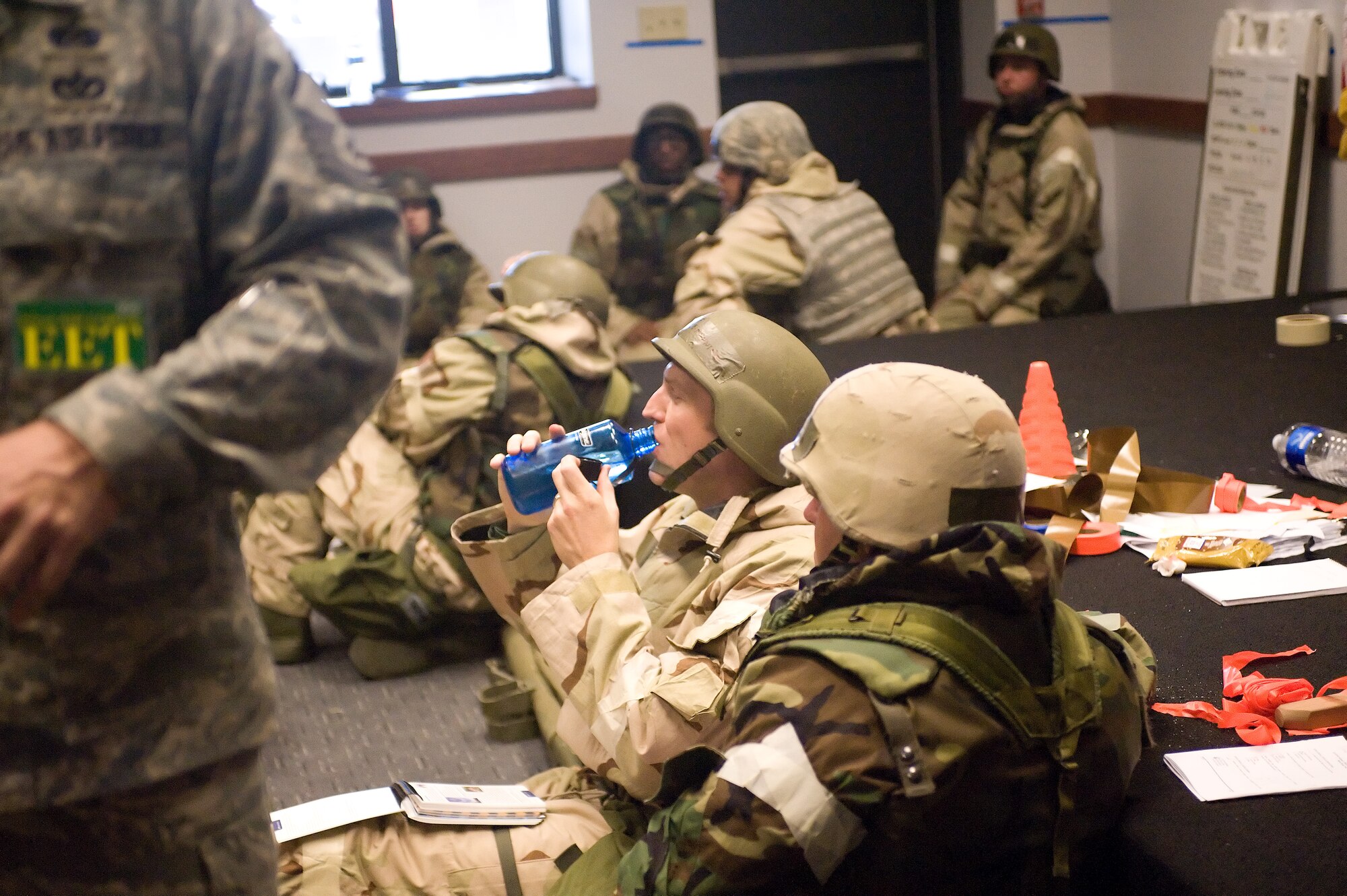 Team Dover members take a break between exercises during the Ability to Survive and Operate training April 20, 2011, at Dover Air Force Base, Del. ATSO tested Team Dover Airmen on changing from Mission Oriented Protection Posture 2 to MOPP 4 during the course of the training. (U.S. Air Force photo by Steve Kotecki)