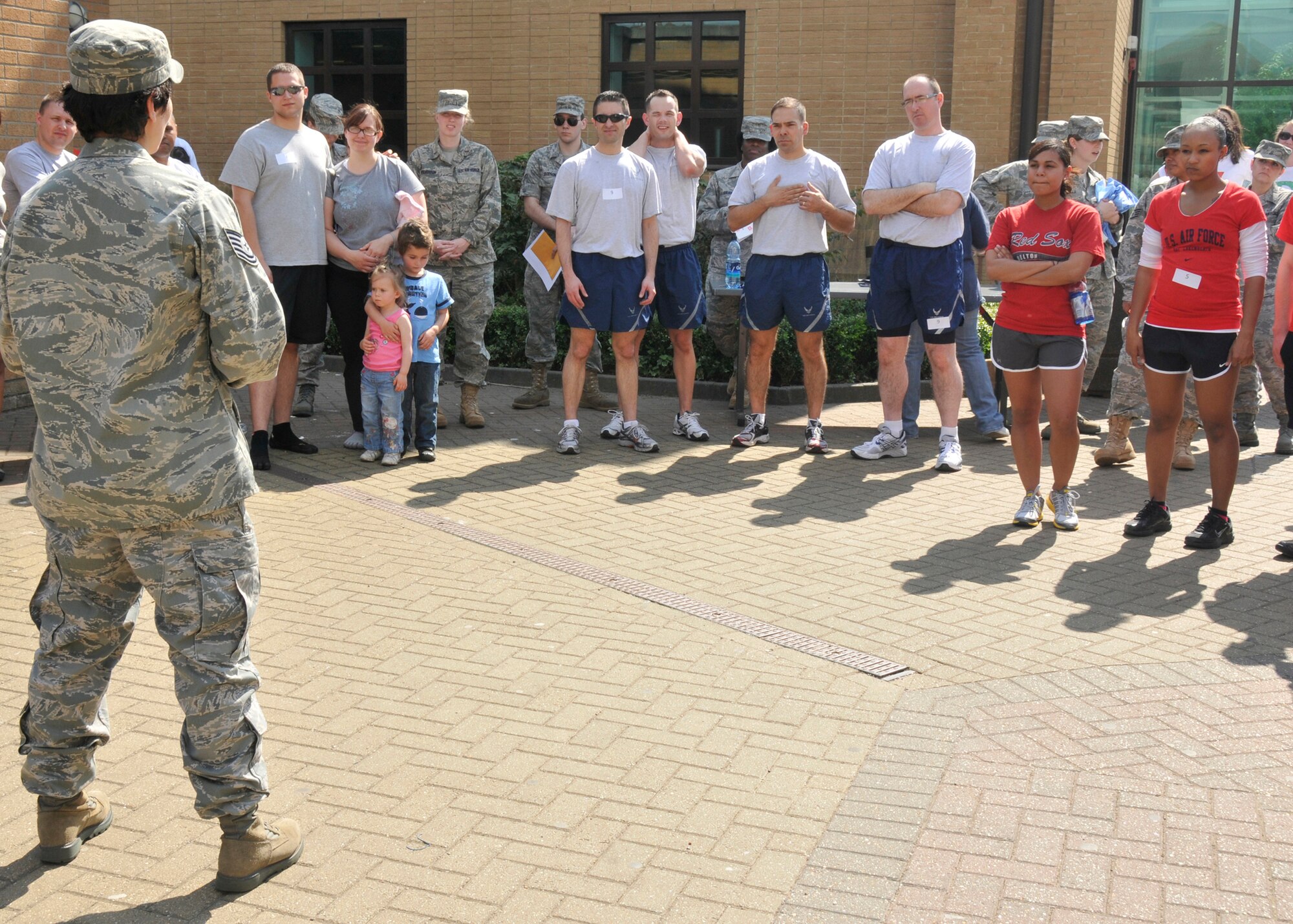ROYAL AIR FORCE LAKENHEATH, England ? Tech. Sgt. Michelle Mayhew, 48th Fighter Wing Sexual Assault Response Coordinator NCO in charge, (left), briefs the teams for the Sexual Assault Awareness Month Amazing Race at the fitness center on April 22, 2011. Nine teams of four were given a series of challenges at various locations around the base. The winning team received a one-day pass from Col. William Lewis, 48th FW vice commander, in addition to the guest cards for a free meal at any Army and Air Force Exchange Service fast food restaurant that were also given to the second, third and fourth place teams. (U.S. Air Force photo/Senior Airman Tiffany M. Deuel)