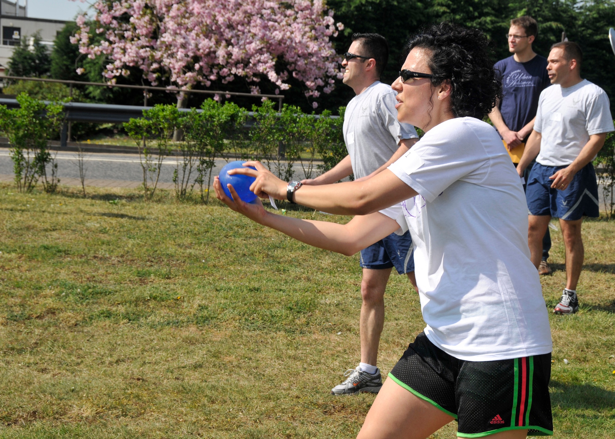 Staff Sgt. Heather Pelley, 48th Contracting Squadron contract specialist, tosses a balloon to a teammate during the Sexual Assault Awareness Month Amazing Race at Defender Park on April 22, 2011. The winning team received a one-day pass from Col. William Lewis, 48th Fighter Wing vice commander, in addition to the guest cards for a free meal at any Army and Air Force Exchange Service fast food restaurant that were also given to the second, third and fourth place teams. (U.S. Air Force photo/Senior Airman Tiffany M. Deuel)