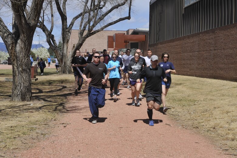 PETERSON AIR FORCE BASE, Colo. – About 210 Airmen and Department of Defense civilians take off for a 5- or 10- kilometer run April 22, 2011 behind the Peterson Sports and Fitness Center in celebration of Earth Day and Sexual Assault Awareness Month. The 21st Space Wing hosted a number of events to celebrate Earth Day, including a tree-planting ceremony and trash pickup. The wing also hosted guest speakers in April in recognition of Sexual Assault Awareness Month. The two events culminated with the run, for which participants also received free Sexual Assault Awareness Month T-shirts. (U.S. Air Force photo/Robb Lingley)