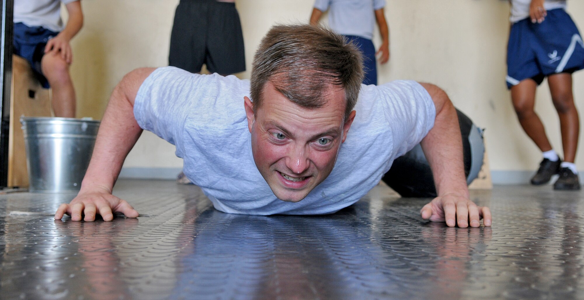 SPANGDAHLEM AIR BASE, Germany – Staff Sgt. Daniel Podnar, 52nd Communications Squadron policy and evaluations craftsman, performs push-ups  during a pledge drive at the Combat Fitness Center to raise money for sexual assault victims in the Eifel here April 25. Thirty-two people attended the event and raised approximately $600 by performing 348 rounds of exercises equaling 1,760 pull-ups, 3,500 push-ups, and 5,220 squats. The money will be used to provide food, clothing and lodging to sexual assault victims in the Eifel region. (U.S. Air Force photo/Senior Airman Nick Wilson)