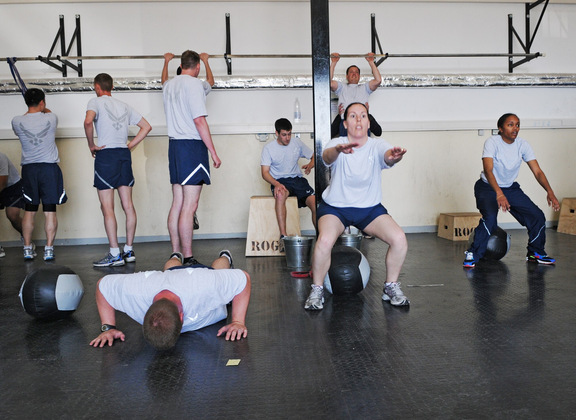 SPANGDAHLEM AIR BASE, Germany – Airmen from the 52nd Communications Squadron perform pull-ups, squats and push-ups during a pledge drive at the Combat Fitness Center to raise money for sexual assault victims in the Eifel here April 25. Thirty-two people attended the event and raised approximately $600 by performing 348 rounds of exercises equaling 1,760 pull-ups, 3,500 push-ups, and 5,220 squats. The money will be used to provide food, clothing and lodging to sexual assault victims in the Eifel region. (U.S. Air Force photo/Senior Airman Nick Wilson)