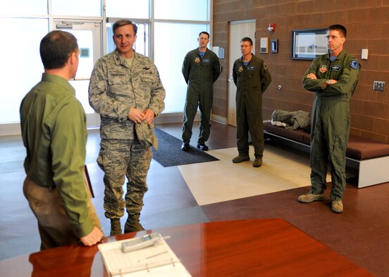 Col. Jeffrey Taliaferro, 28th Bomb Wing commander, is briefed before he prepares to tour the upgraded B-1 simulator April 13, 2011, at Ellsworth Air Force Base. The 18.4 million dollar upgrade covers all four B-1 simulators, two of which are here at Ellsworth and the other two are at Dyess Air Force Base. (U.S. Air Force photo/Senior Airman Adam Grant)