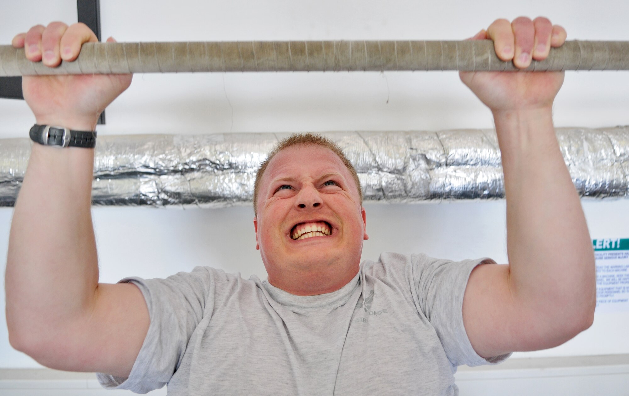 SPANGDAHLEM AIR BASE, Germany – Tech. Sgt. Nathaniel Thompson, 52nd Communications Squadron cyber system operations NCO in charge, performs pull-ups during a pledge drive at the Combat Fitness Center to raise money for sexual assault victims in the Eifel here April 25. Thirty-two people attended the event and raised approximately $600 by performing 348 rounds of exercises equaling 1,760 pull-ups, 3,500 push-ups, and 5,220 squats. The money will be used to provide food, clothing and lodging to sexual assault victims in the Eifel region. (U.S. Air Force photo/Senior Airman Nick Wilson)