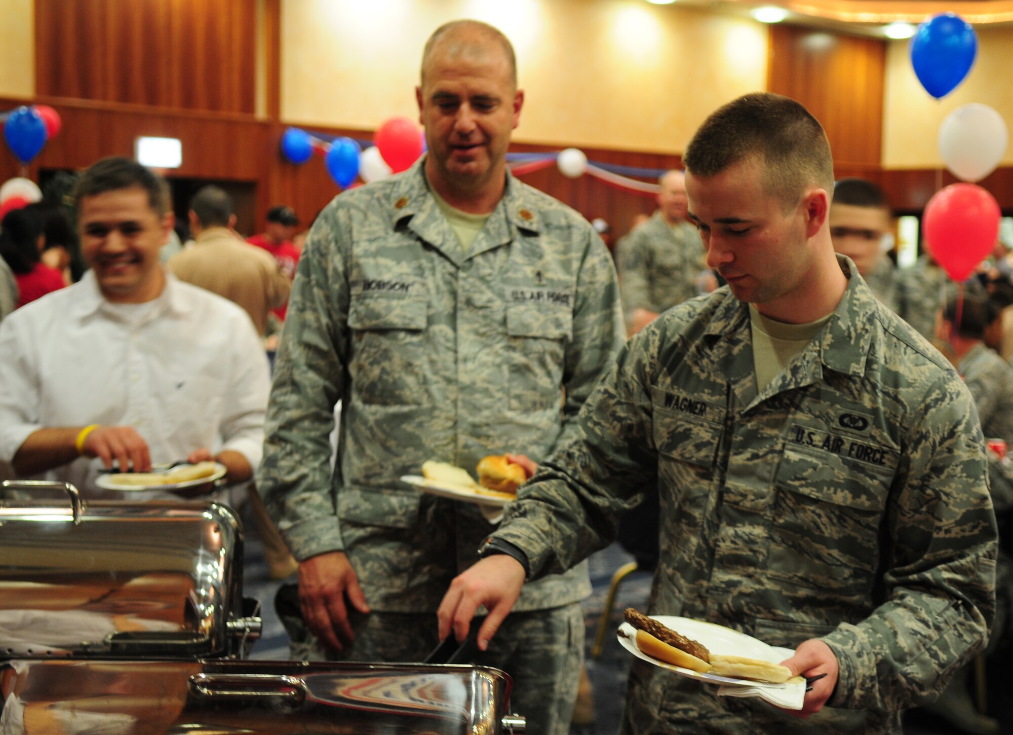 SPANGDAHLEM AIR BASE, Germany – Airmen and families partake in free food and drinks during the Operation Odyssey Dawn Bash at Club Eifel here April 22. The event was held to thank service members and families for all their hard work and support during Operation Odyssey Dawn. (U.S. Air Force photo/Airman 1st Class Dillon Davis)
