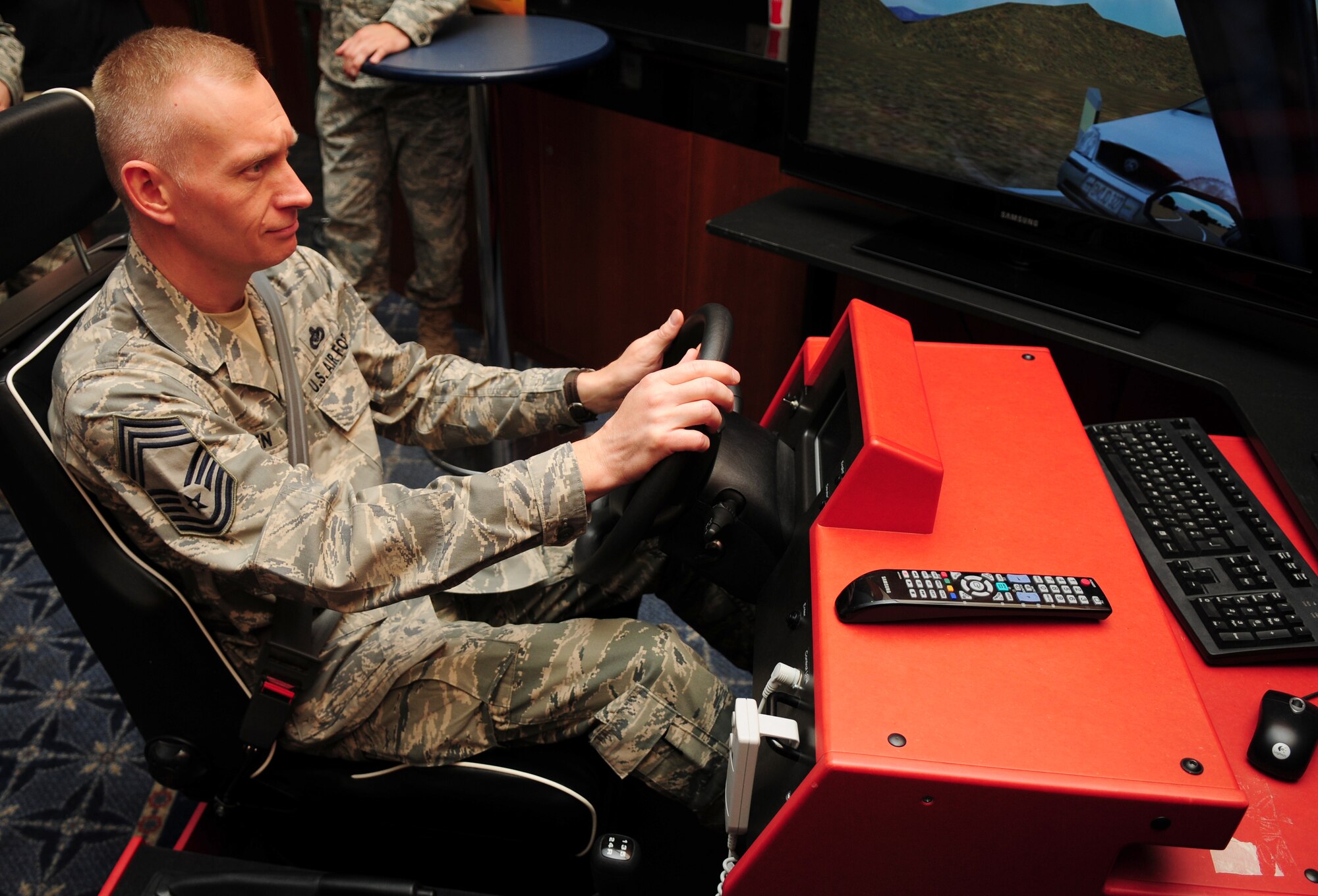 SPANGDAHLEM AIR BASE, Germany –Chief Master Sgt. Richard Lien, 52nd Civil Engineer Squadron fire chief, drives a drunken driving simulator as part of a 52nd Fighter Wing Safety demonstration during the Operation Odyssey Dawn Bash at Club Eifel here April 22. The event was held to thank service members and families for all their hard work and support during Operation Odyssey Dawn. (U.S. Air Force photo/Airman 1st Class Dillon Davis)