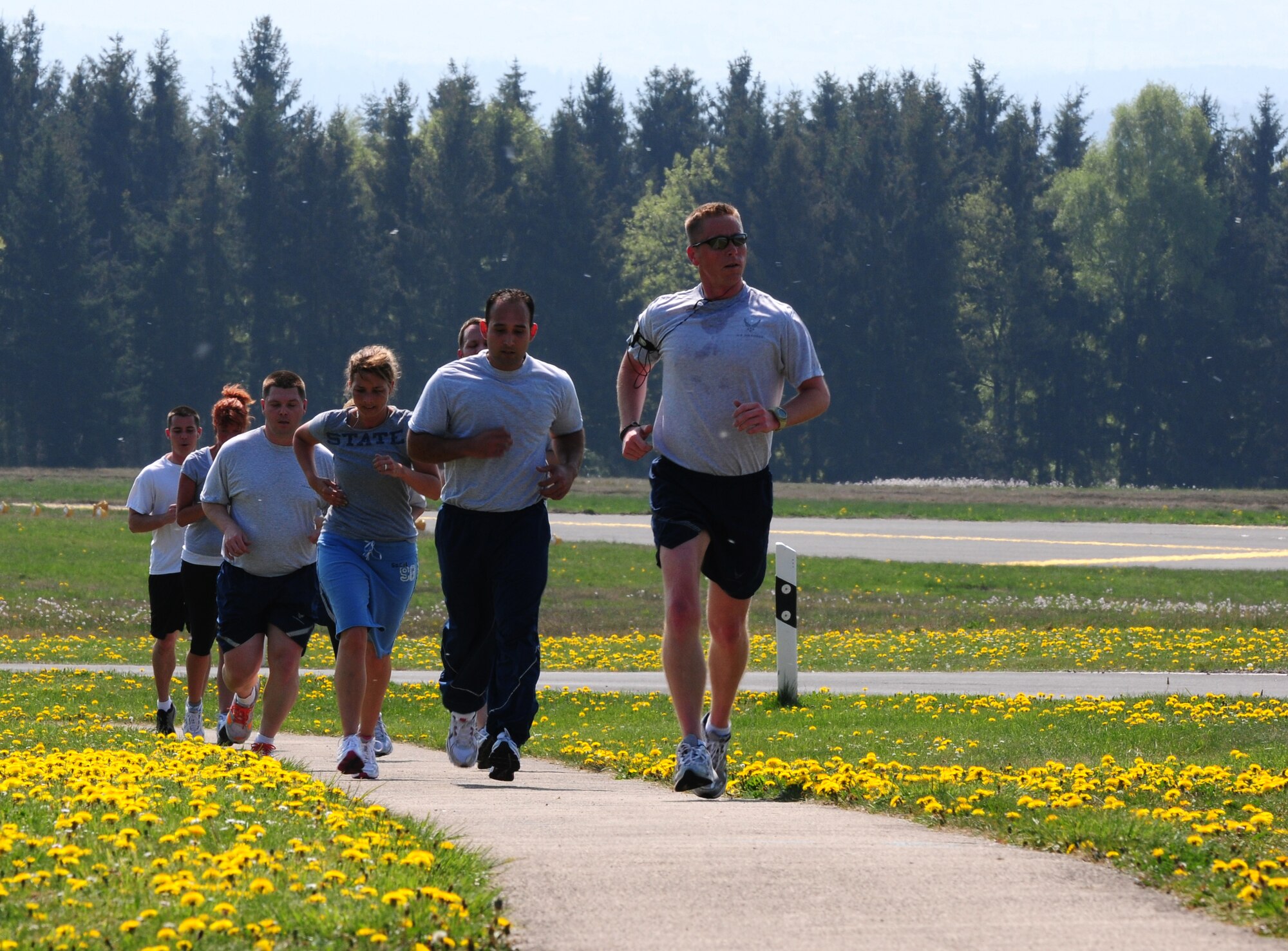 SPANGDAHLEM AIR BASE, Germany — Airmen and family members from the 52nd Fighter Wing run up Perimeter Road during a 5k run April 20. The run was held to promote sexual assault awareness and Earth Day Awareness among Airmen and families. (U.S. Air Force photo/Airman 1st Class Dillon Davis)