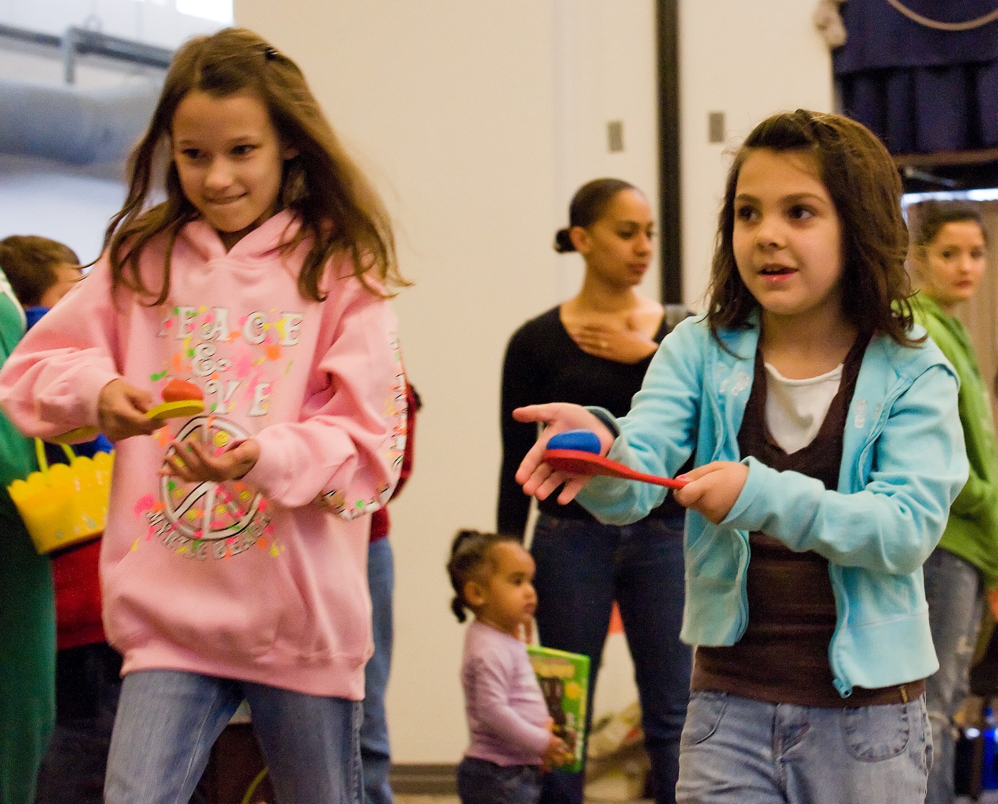 Makensie Arnall (left) and Madison Tulloch run with Easter Eggs in spoons during the Annual Easter Egg Hunt April 23, 2011, at The Landings Club Dover Air Force Base, Del. The event included sack races, a bouncy castle, face painting and other games. (U.S. Air Force photo by Airman 1st Class Jacob Morgan)