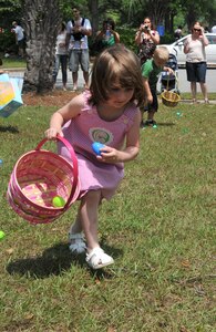 Four-year-old Emma Strealy, daughter of Alan Strealy, a Marine staff sergeant, puts an Easter Egg into her pink basket during an Easter Egg Hunt as part of the Month of the Military Child Festival April 23, on Joint Base Charleston - Air Base. After the Easter Egg Hunt, children enjoyed free games, food and prizes. (U.S. Air Force photo /Airman 1st Class Jared Trimarchi)
