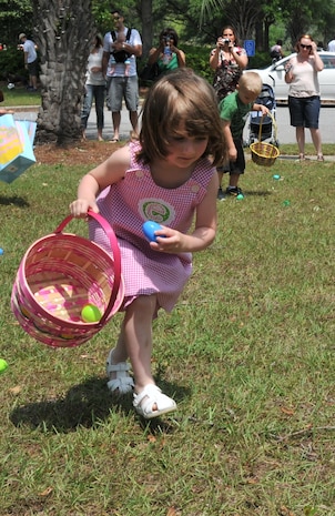 Four-year-old Emma Strealy, daughter of Alan Strealy, a Marine staff sergeant, puts an Easter Egg into her pink basket during an Easter Egg Hunt as part of the Month of the Military Child Festival April 23, on Joint Base Charleston - Air Base. After the Easter Egg Hunt, children enjoyed free games, food and prizes. (U.S. Air Force photo /Airman 1st Class Jared Trimarchi)

