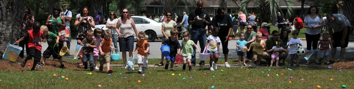 Children ages three to four run and grab Easter Eggs during the Month of the Military Child Festival April 23, on Joint Base Charleston - Air Base. Nearly 300 children enjoyed free games, food, prizes and a visit from the Easter bunny. (U.S. Air Force photo /Airman 1st Class Jared Trimarchi)