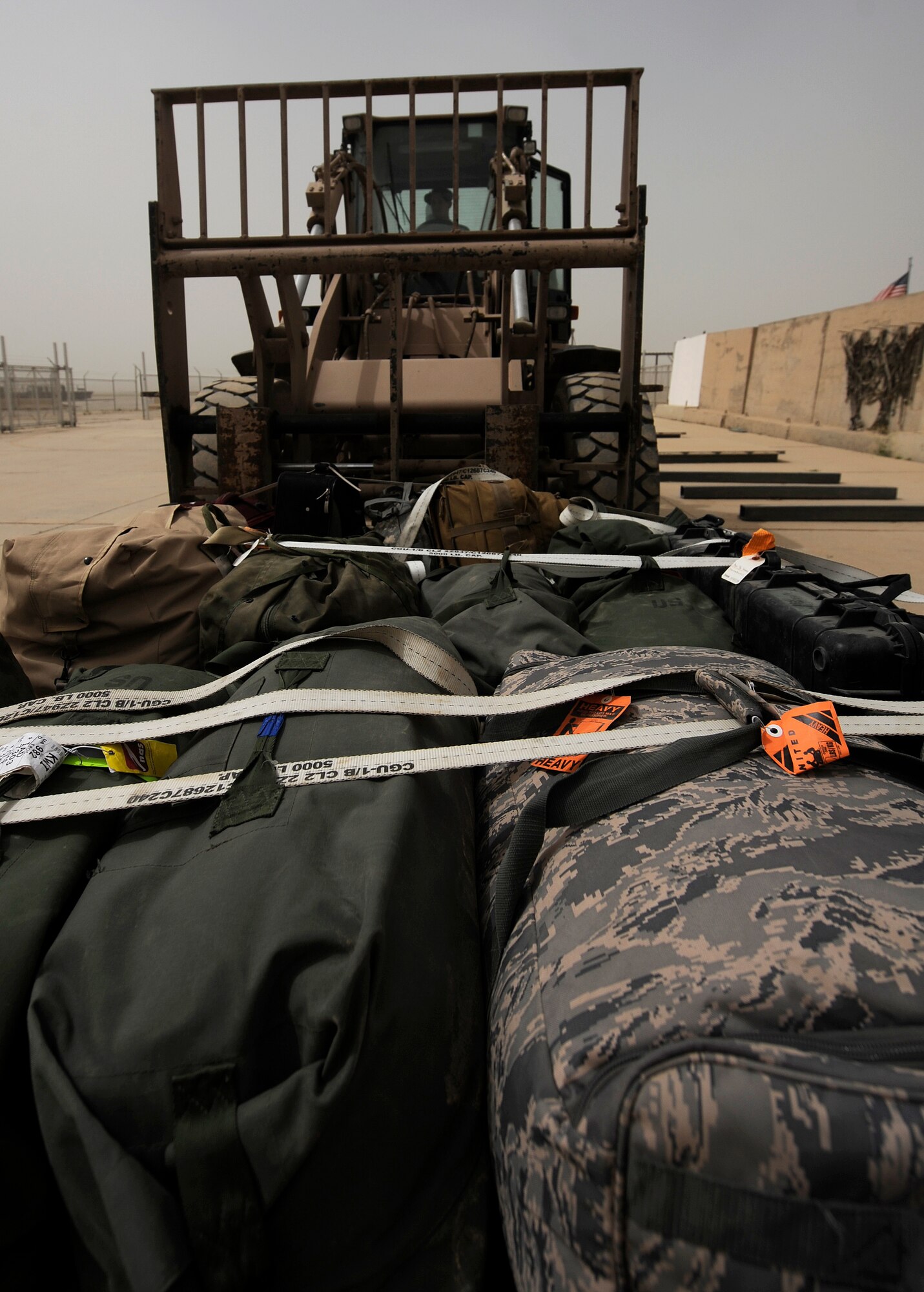 KIRKUK REGIONAL AIR BASE, Iraq -- Senior Airman Jacob Tate, 321st Expeditionary Logistics Readiness Squadron aerial port operations technician, weighs baggage pallets for an outgoing aircraft during a training session with Iraqi air force airmen April 6. Airman Tate is an Air National Guardsman deployed from the 171st Air Refueling Wing, Pittsburgh, Pa.(U.S. Air Force/Tech. Sgt. Jason Lake)