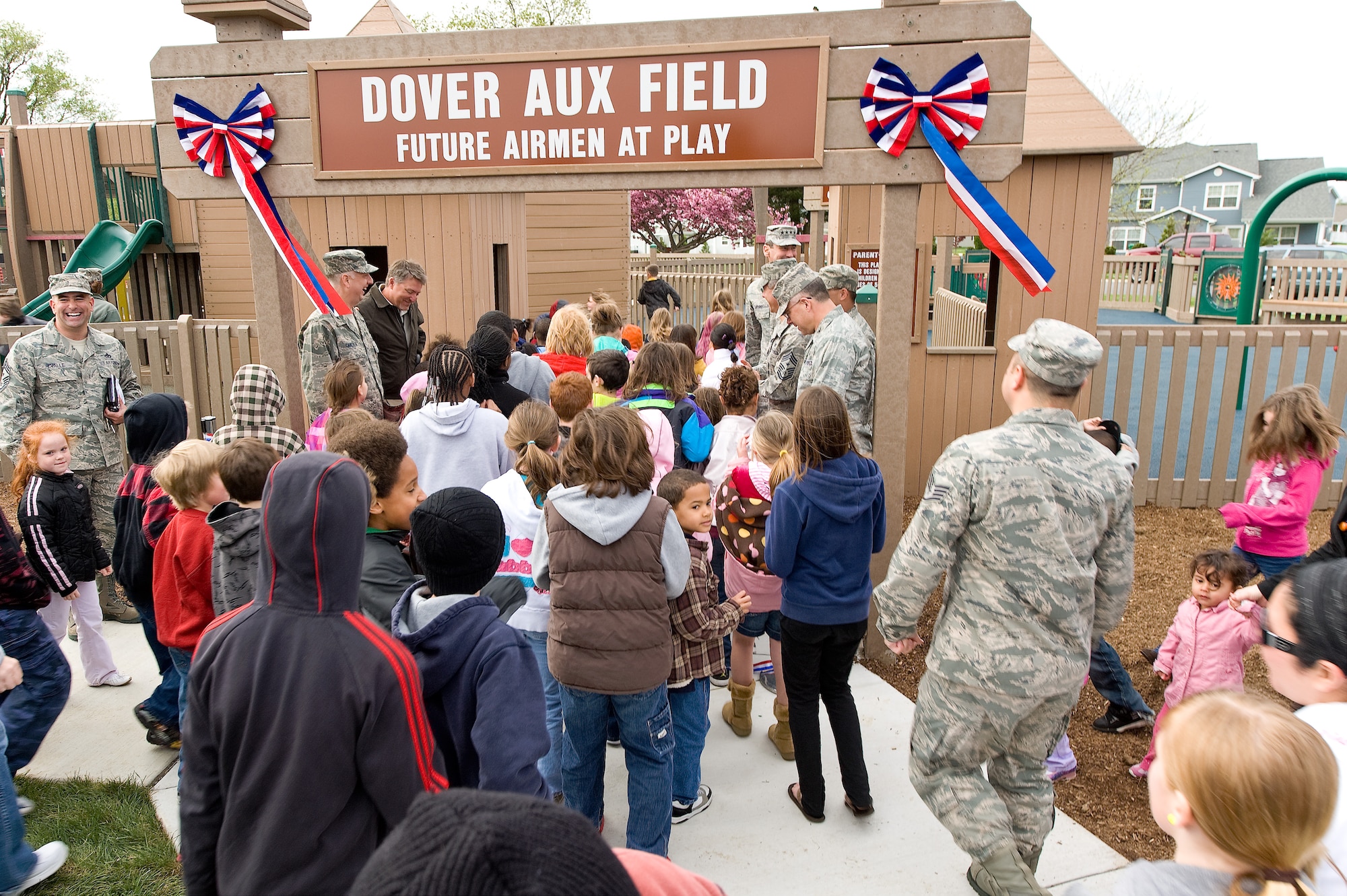Children rush the new Dover Aux Field April 22, 2011, at Liberty Park at Dover Air Force Base, Del. The children rushed in only seconds after the ribbon was cut. (U.S. Air Force photo by Airman 1st Class Jacob Morgan)