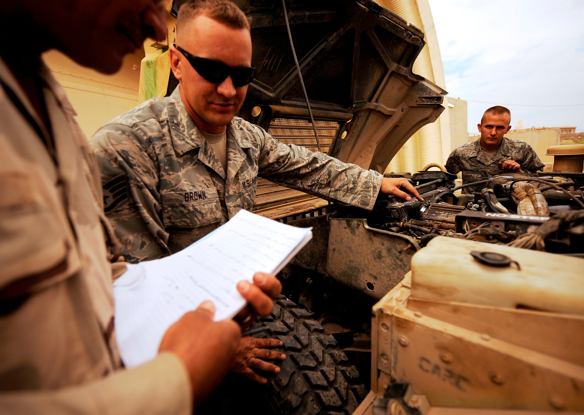 KIRKUK REGIONAL AIR BASE, Iraq -- Staff Sgt. Jedidiah Brown, 321st Expeditionary Logistics Readiness Squadron vehicle maintainer, shows Iraqi airmen tricks of the trade when maintaining humvees during a training session April 6. Sergeant Brown is deployed from F.E. Warren Air Force Base, Wyo., and calls Troy, Pa., his hometown. (U.S. Air Force/Tech. Sgt. Jason Lake)