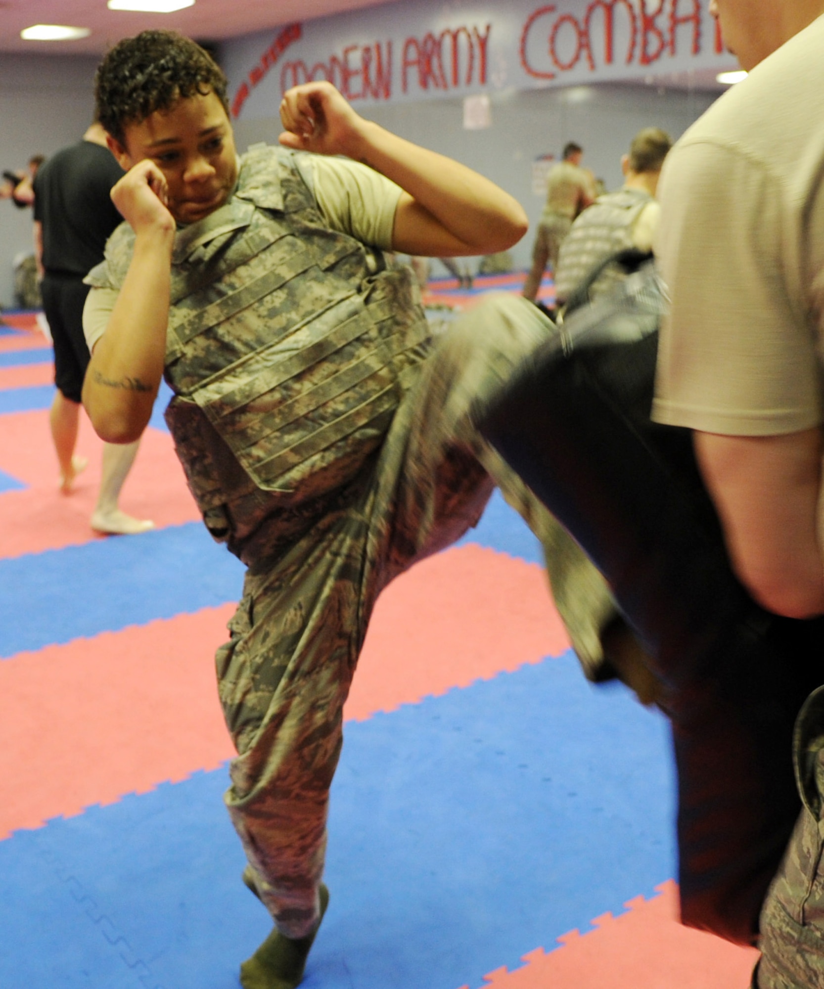 JOINT BASE BALAD, Iraq--Senior Airman Corinna Grimm, 332nd Expeditionary Logistics Readiness Squadron receiving journeyman, executes a Spartan kick during combat skills course April 24, 2011. Coaches from the U.S. Air Force Academy came here to teach the five-day course. (U.S. Air Force photo/Staff Sgt. Keyonna Fennell)