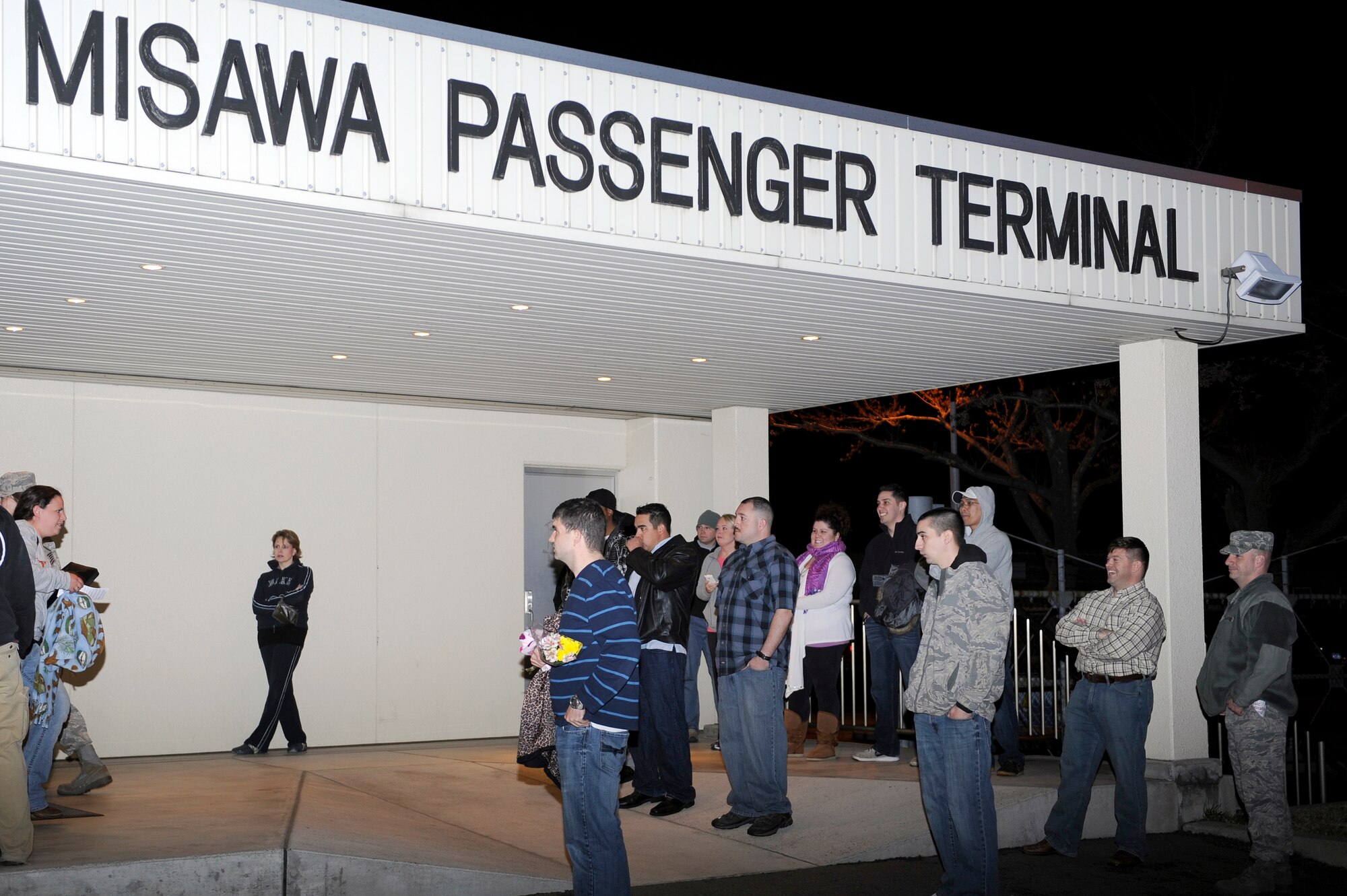 MISAWA AIR BASE, Japan -- Misawa residents wait outside the passenger terminal for their loved ones arrival April 25. More than 1,300 dependents from Misawa participated in the Department of State-approved voluntary departure program for families affected by the March 11 earthquake. (U.S. Air Force photo by Staff Sgt. Marie Brown\Released)