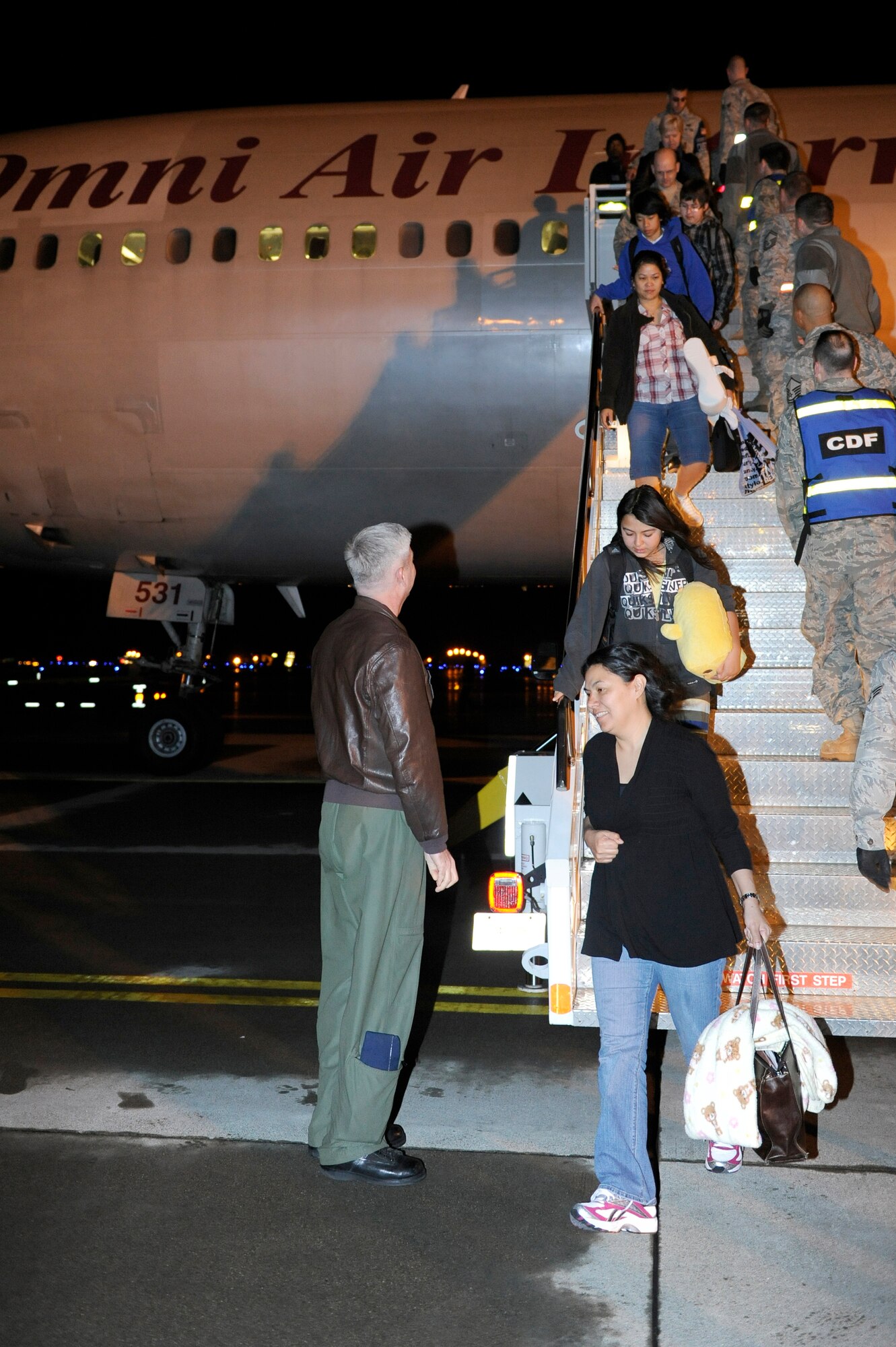 MISAWA AIR BASE, Japan -- Col. Al Wimmer, 35th Fighter Wing vice commander, welcomes back military families April 25. Military family members, Defense Department civilians and contractors assigned to mainland Japan were eligible to depart for a period not to exceed 30 days under the Department of Defense voluntary authorized departure order. (U.S. Air Force photo by Staff Sgt. Marie Brown\Released)