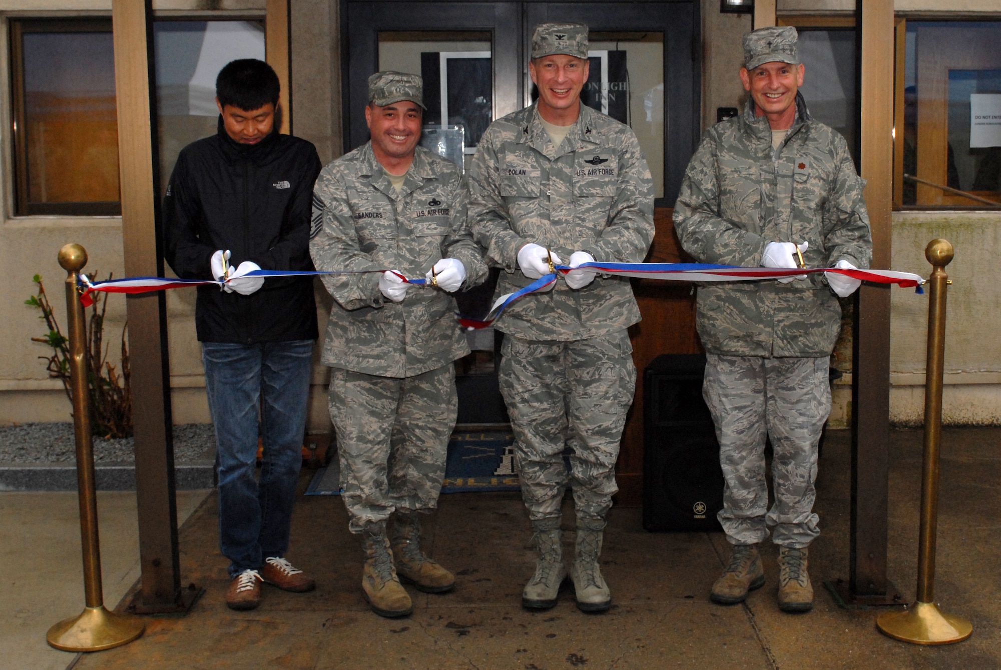 KUNSAN AIR BASE, Republic of Korea -- Col. John Dolan, 8th Fighter Wing commander, leads the ribbon cutting ceremony at the newly renovated SonLight Inn here April 22. The SonLight Inn had been shut down while repairs were made and upgraded equipment was installed. (U.S. Air Force photo/Tech. Sgt. Jonathan Pomeroy)