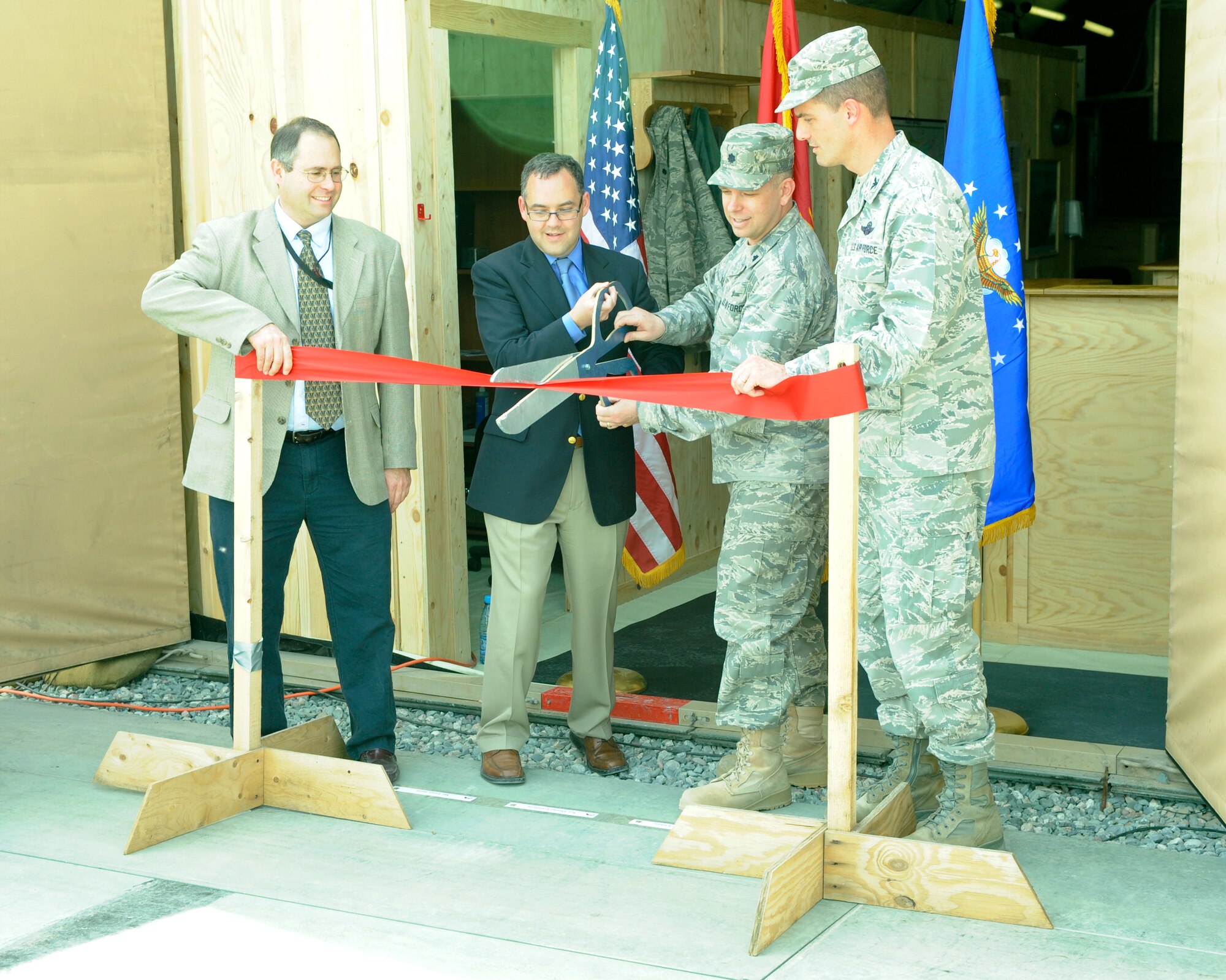 TRANSIT CENTER AT MANAS, Kyrgyzstan -The Honorable Daniel Ginsberg, Assistant Secretary of the Air Force for Manpower and Reserve Affairs, Lt. Col. John Elshaw, Theater Security Cooperation Division  director, and Col. Dwight Sones, Transit Center at Manas director, mark the opening of the TSC here April 23.  Secretary Ginsberg also toured the transit center to take a look at the day-to-day operations and held an "All Call" in Pete's Place to answer questions from transit center Airmen. (U.S. Air Force photo/Tech. Sgt. Jerome C. Baysmore)