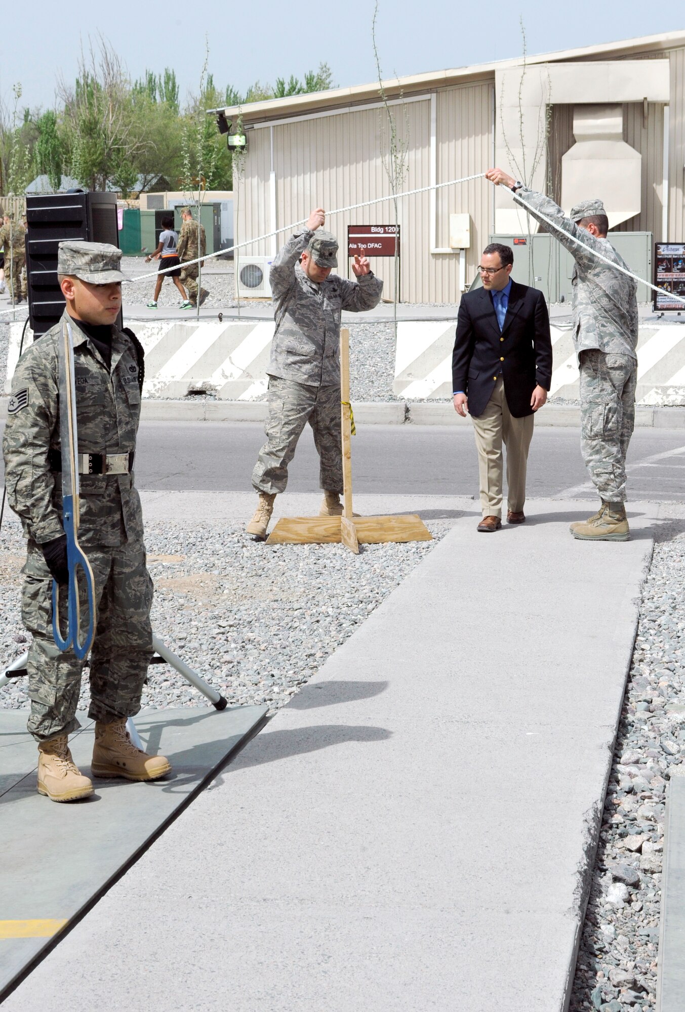 TRANSIT CENTER AT MANAS, Kyrgyzstan -The Honorable Daniel Ginsberg, Assistant Secretary of the Air Force for Manpower and Reserve Affairs, enters to officiate the Theater Security Cooperation Division stand up ceremony here April 23.  Secretary Ginsberg also toured the transit center to take a look at the day-to-day operations and held an "All Call" in Pete's Place to answer questions from transit center Airmen. (U.S. Air Force photo/Tech. Sgt. Jerome C. Baysmore)