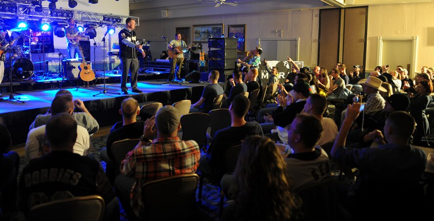 KUNSAN AIR BASE, Republic of Korea -- Col. John Dolan, 8th Fighter Wing commander, addresses a crowd of more than 250 Wolf Pack Airmen patiently waiting for Darryl Worley, a U.S. country singer, to “enter stage left” at the Loring Club here April 23. Mr. Worley visited to show his appreciation for everything Kunsan does to ensure he and his family stays safe. (U.S. Air Force photo/Senior Airman Benjamin Stratton)