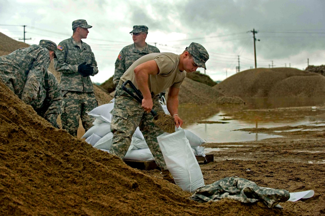 U.S. Army soldiers fill sandbags at the Indiana Department of Transportation branch in Vincennes, Ind., to support flooding in the area, April 25, 2011. The soldiers alternated working six-hour shifts around the clock to fill an order of 100,000 sandbags. 
