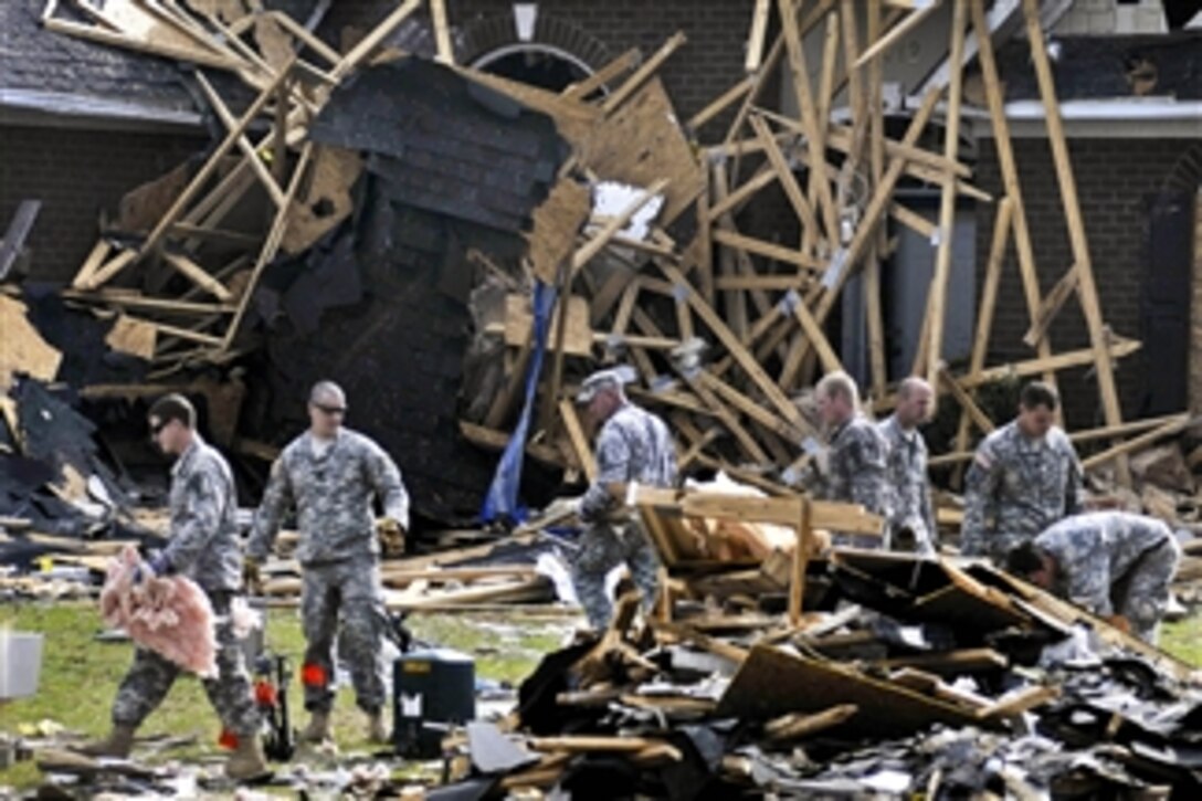 About 50 U.S. Army soldiers volunteer to help clean up a neighborhood that had been hit by tornadoes in Fayetteville, N.C., on April 21, 2011.  More than 60 tornadoes touched down across the state of North Carolina on April 16, damaging more than 400 homes and destroying more than 60.  The soldiers are from the U.S Army John F. Kennedy Special Warfare Center and School at Fort Bragg, N.C.  