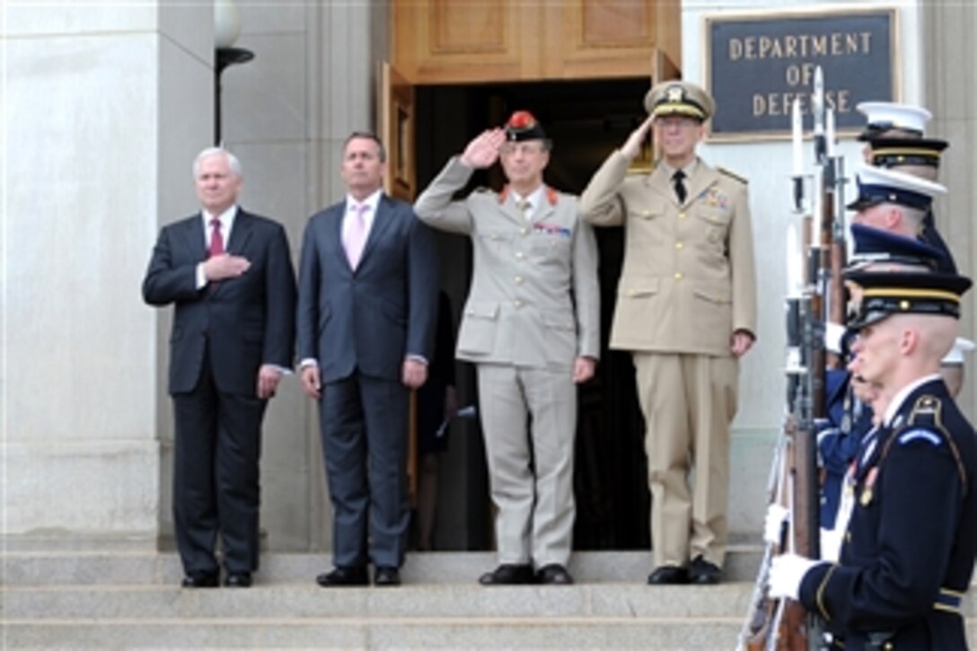 Secretary of Defense Robert M. Gates (left), British Secretary of State for Defense Liam Fox, UK Chief of Defense Sir David Richards and Chairman of the Joint Chiefs of Staff Adm. Mike Mullen (4th from left) render honors during the playing of the British and American national anthems at the Pentagon on April 26, 2011.  