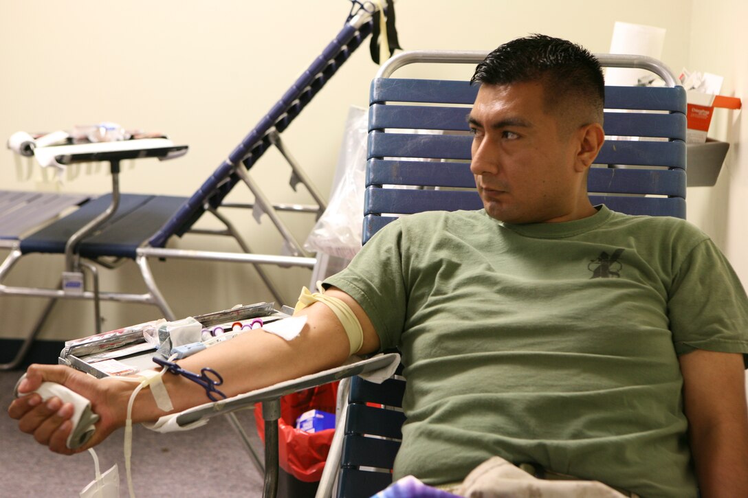 Sgt. Michael Guerrero, a Marine Forces Reserve finance auditor, clinches his fist to help prepare for his blood donation at MarForRes, April 26.  The Blood Center came to MarForRes to give Marines, sailors and Department of Defense civilians a chance to donate blood for hospitals across the Golf Coast.
