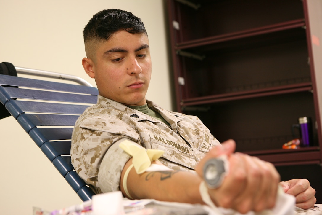 Cpl. Heriberto Maldonado, the disperser in the finance section of Marine Forces Reserve, calmly waits to get his blood drawn at MarForRes, April 26.  The Blood Center came to MarForRes and met their goal of getting at least 40 donors per day.