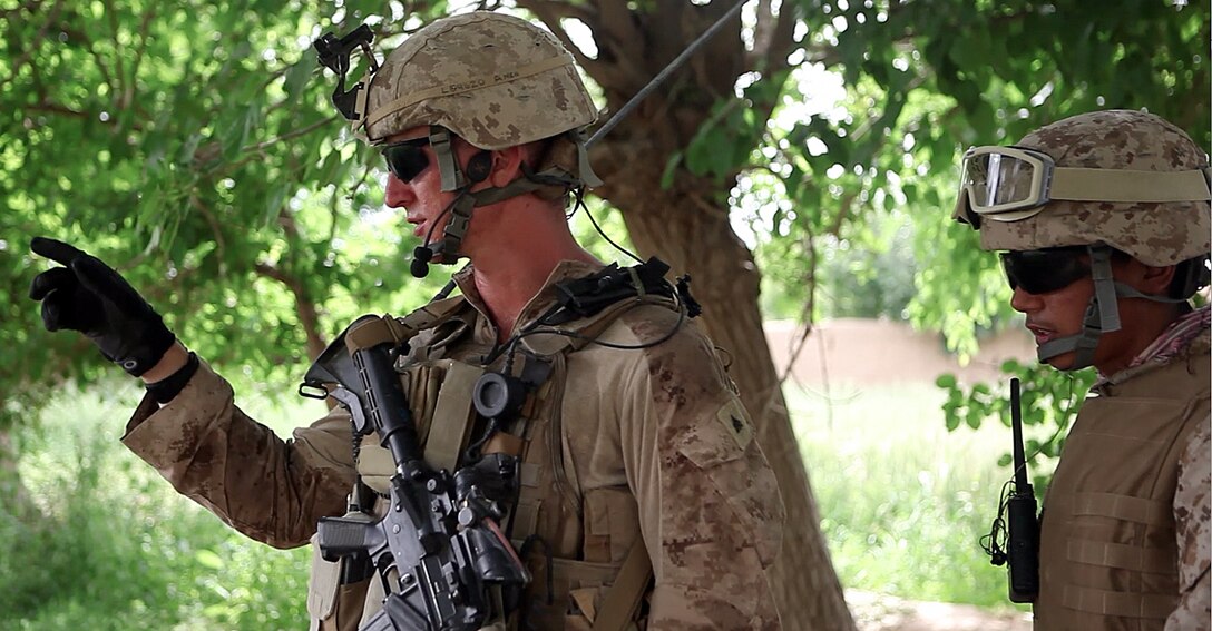 Tulsa, Okla., native Cpl. Daniel Blesi points out the projected route for the interpreter near the base April 27. Blesi is a squad leader with Company L, 3rd Battalion, 4th Marine Regiment. He leads his Marines through the daily foot patrols and does his best to interact with Afghans to build rapport.