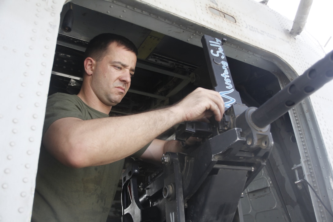 Staff Sgt. Billy Roth prepares a .50-caliber machine gun for use during a troop extraction mission in support of operations in southwestern Afghanistan, April 27. Roth, a native of Anthony, Kan., is a CH-53D crew chief and a weapons and tactics instructor with Marine Heavy Helicopter Squadron 463.