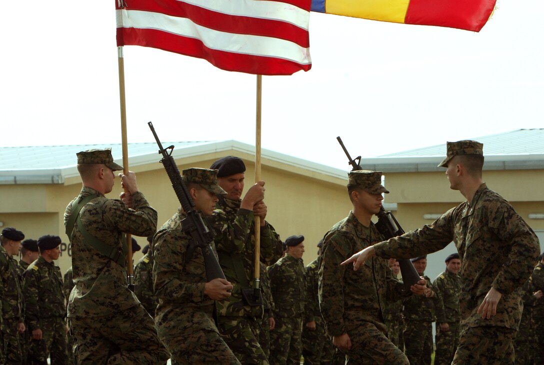 During a rehearsal for the Black Sea Rotational Force 11 Opening Ceremony, Sgt. John H. Hunter, radio operator, BSRF-11, coordinates and synchronizes movements for the American and Romanian colors that will be featured in the event. About 200 Romanian and U.S. Marines, along with Romanian and U.S. military officers, Romanian civilian leaders, and news media attended the opening ceremony on the recently built Mihail Kogalniceau Romanian Land Forces base here.::r::::n::::r::::n::::r::::n::