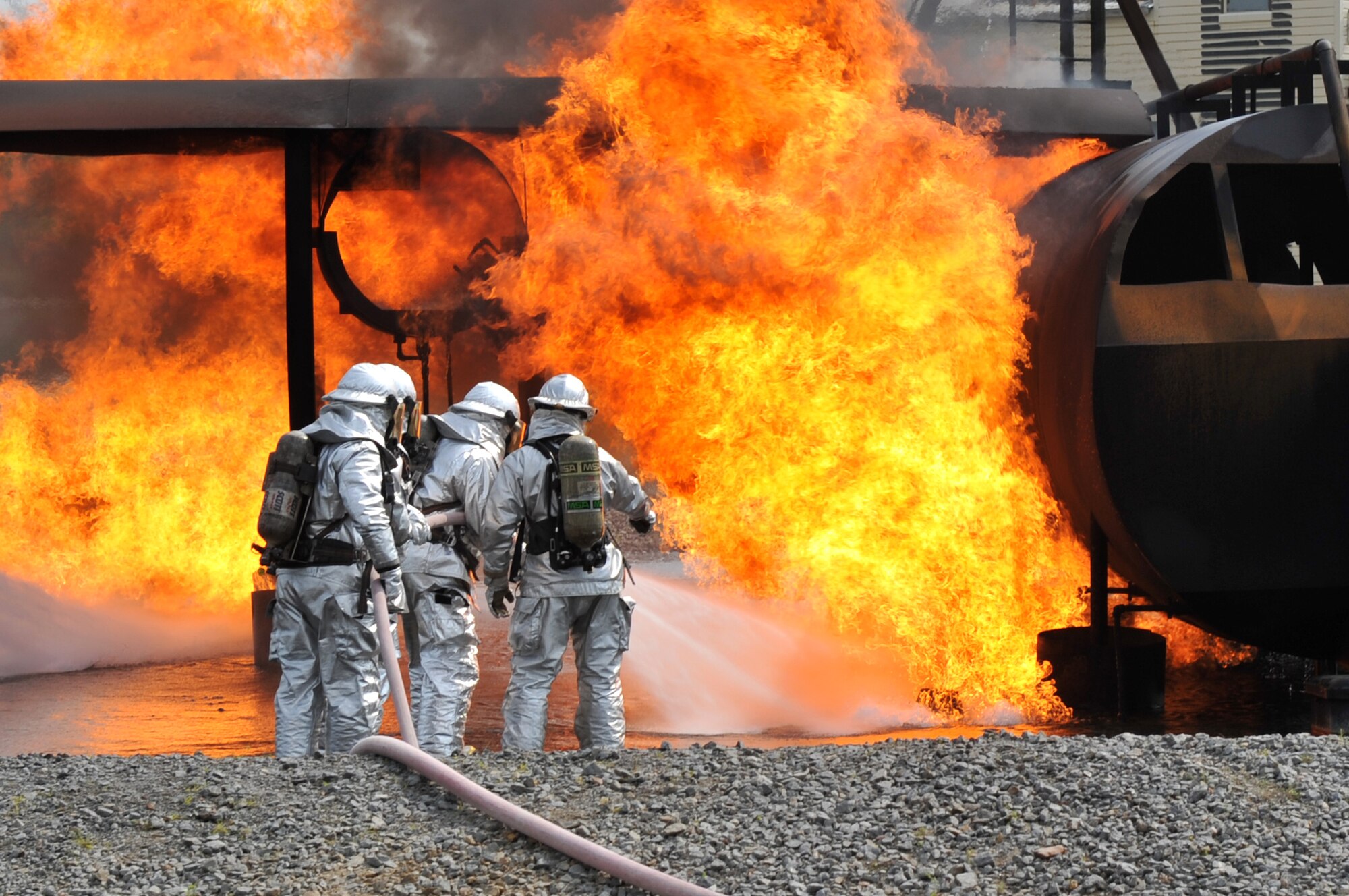 Firefighters from the 19th Civil Engineer Squadron extinguish flames on a mock C-130 during a training burn April 19, 2011, at Little Rock Air Force Base, Ark. The training burn was a joint exercise between 19th CES firefighters and members of Little Rock National Airport. (U.S. Air Force photo by Airman 1st Class Rusty Frank)